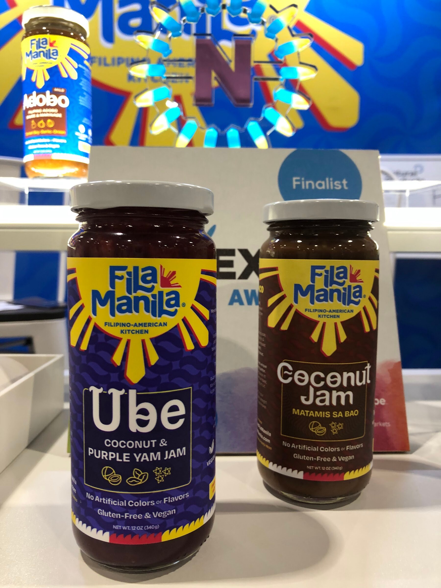 Fila Manila Ube coconut purple yam jam and Coconut Jam jars with a Nexty Awards finalist sign behind them