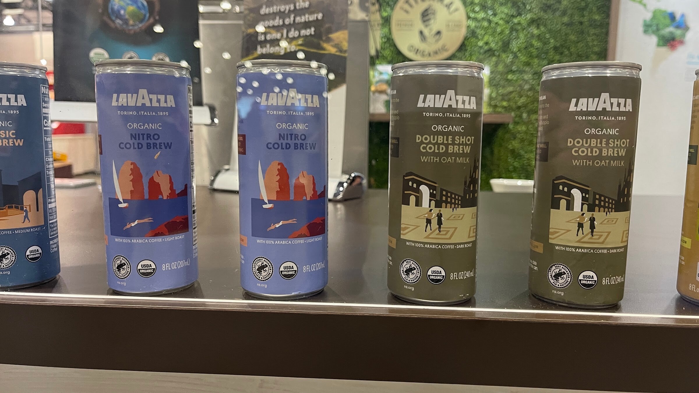 Lavazza organic nitro cold brew and double shot cold brew cans on a steel shelf