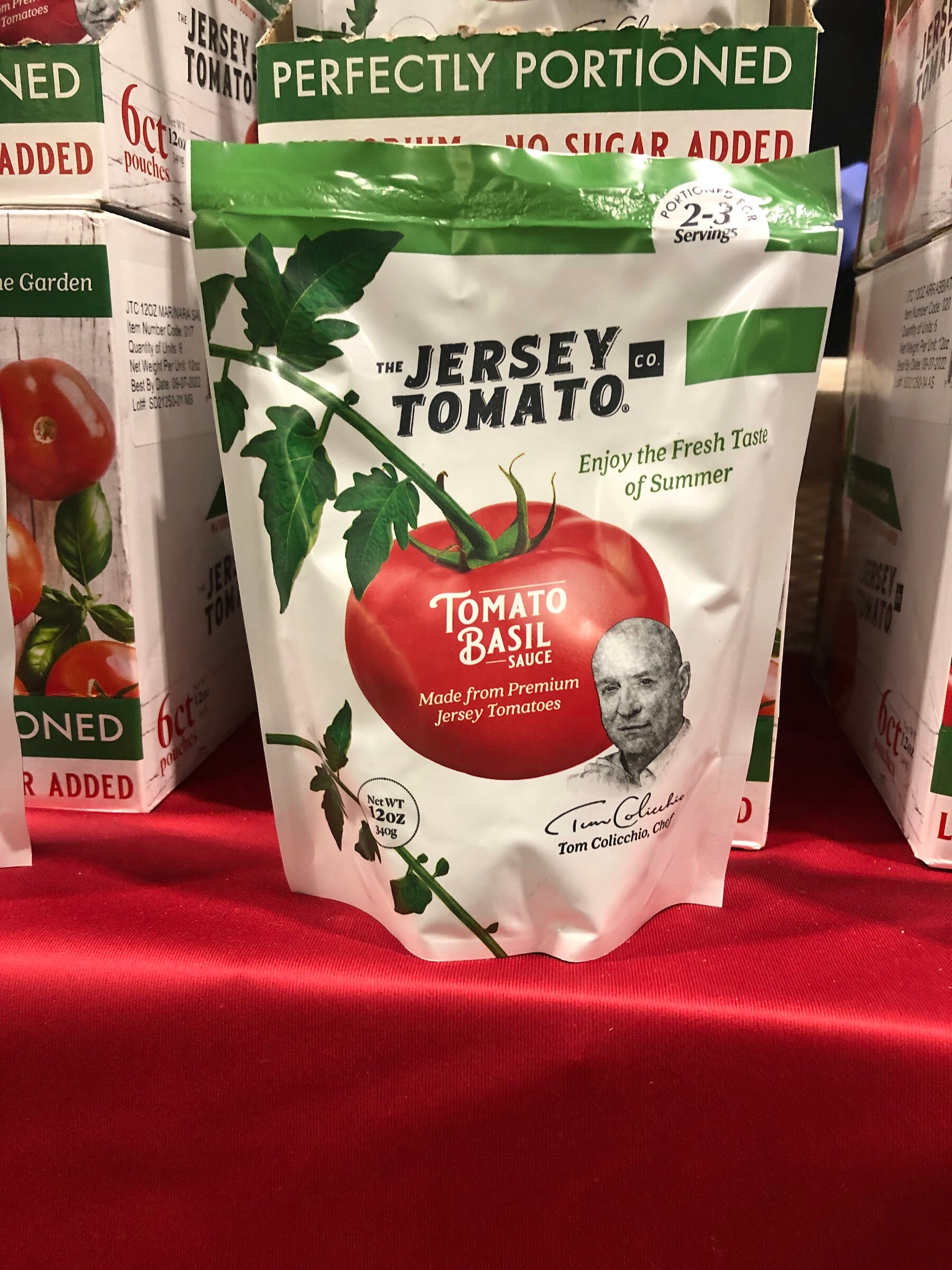 A Jersey Tomato Co. tomato basil sauce pouch on a red tablecloth