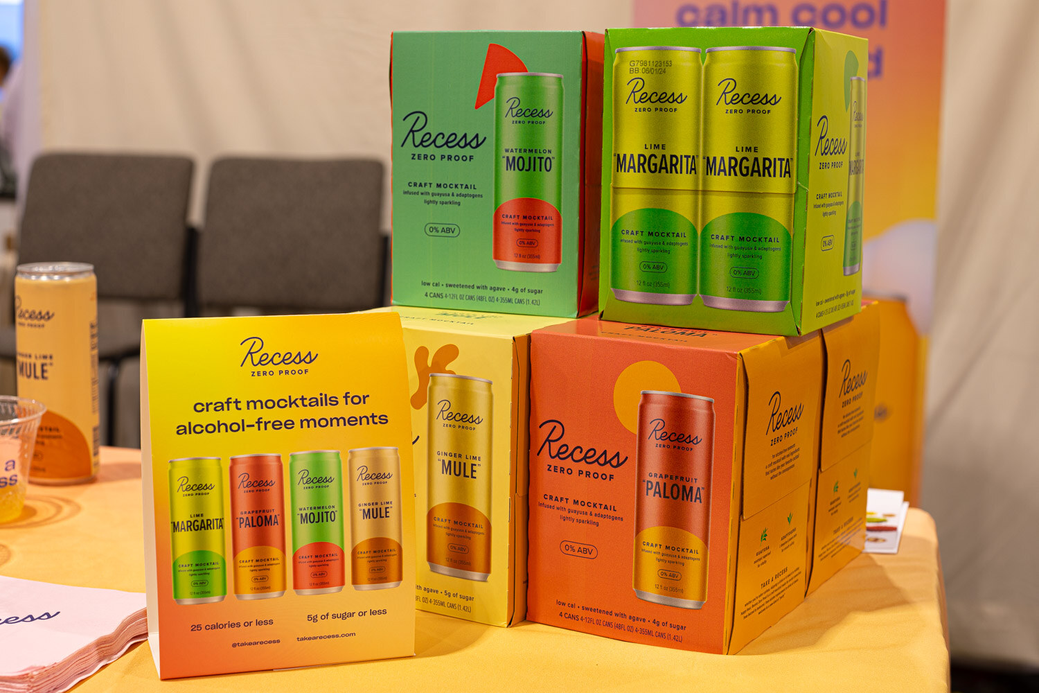 Boxes and cans of Recess craft mocktails, including Mule, Margarita and Paloma flavors, are stacked on a table