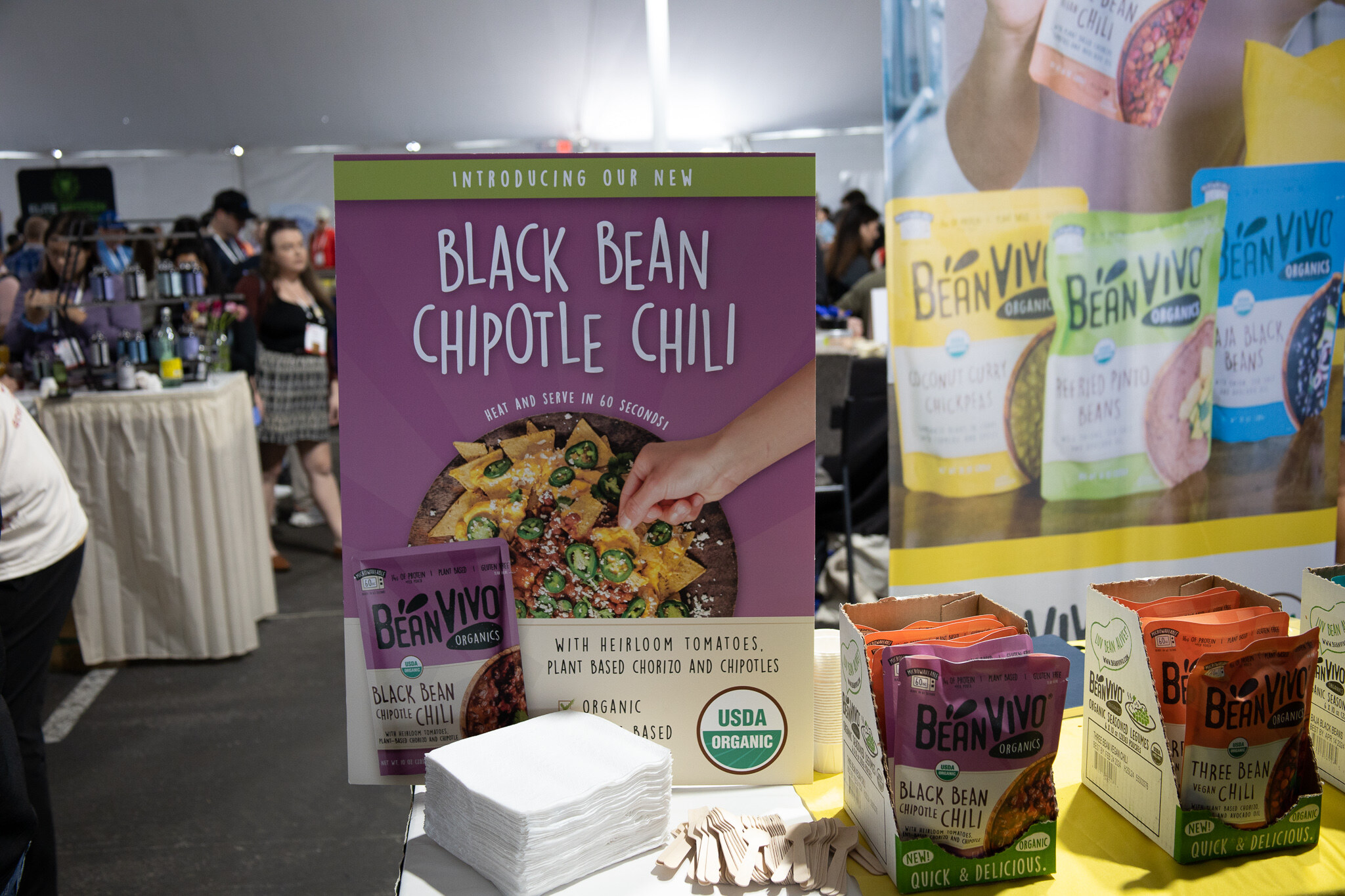 A Bean Vivo Black Bean Chipotle Chili sign beside packaged Bean Vivo meals