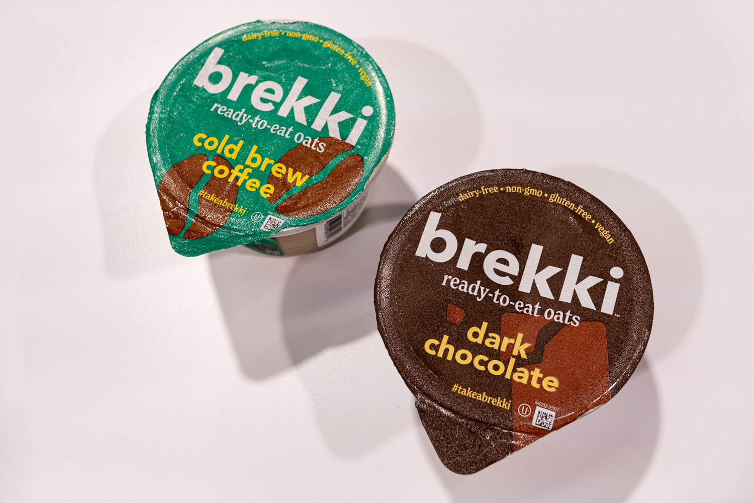 Two Brekki ready-to-eat oat cups in cold brew coffee and dark chocolate