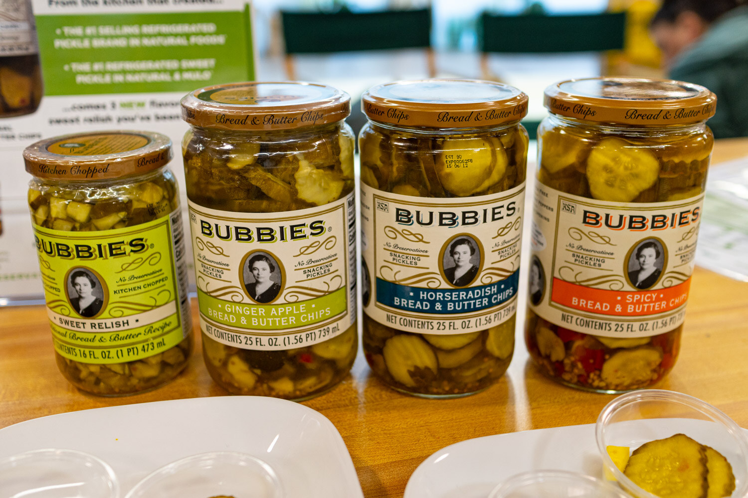 Four jars of Bubbies pickles and relish in a row on a counter