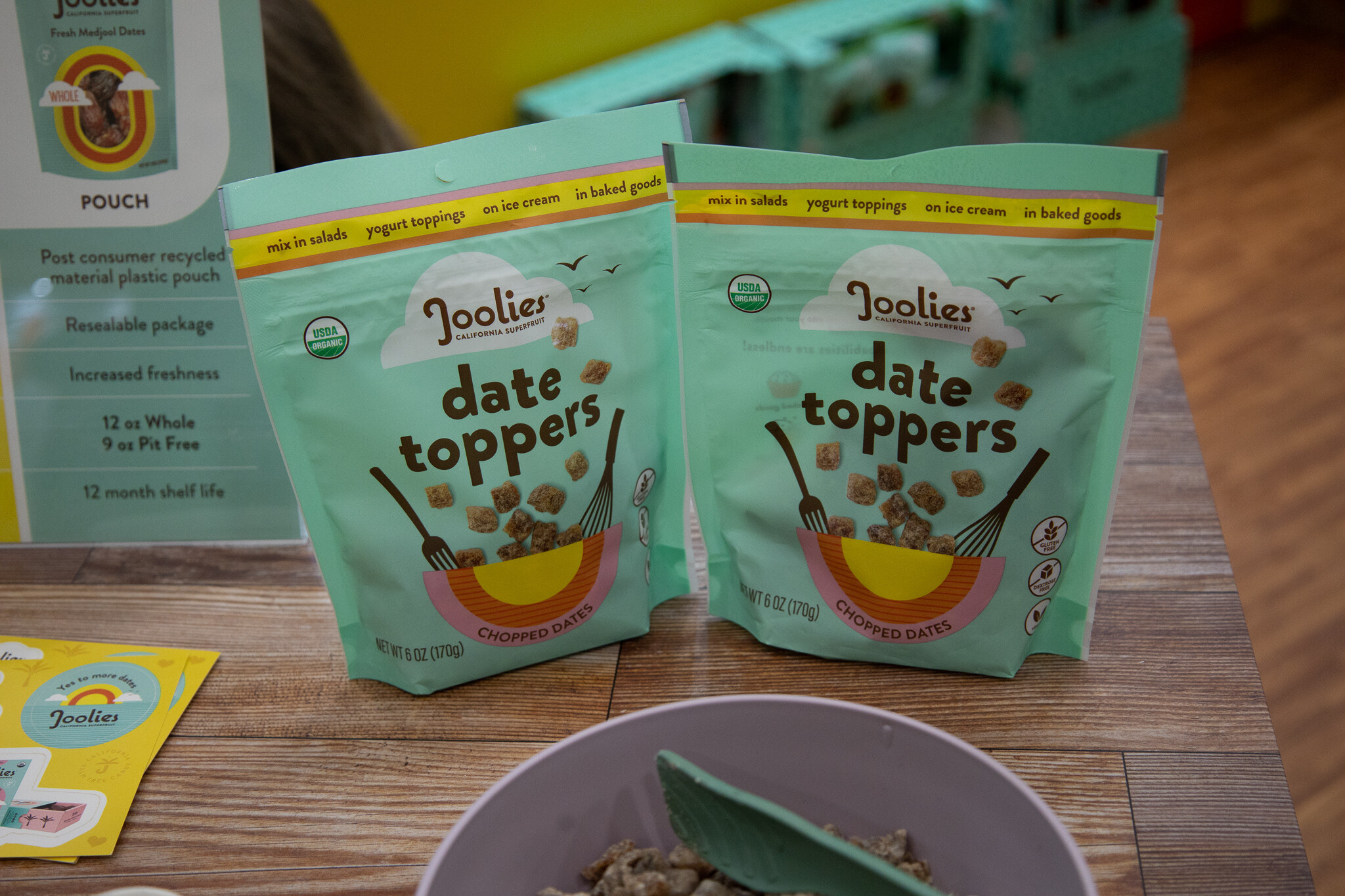 Two Joolies date topper bags in front of a bowl of salad