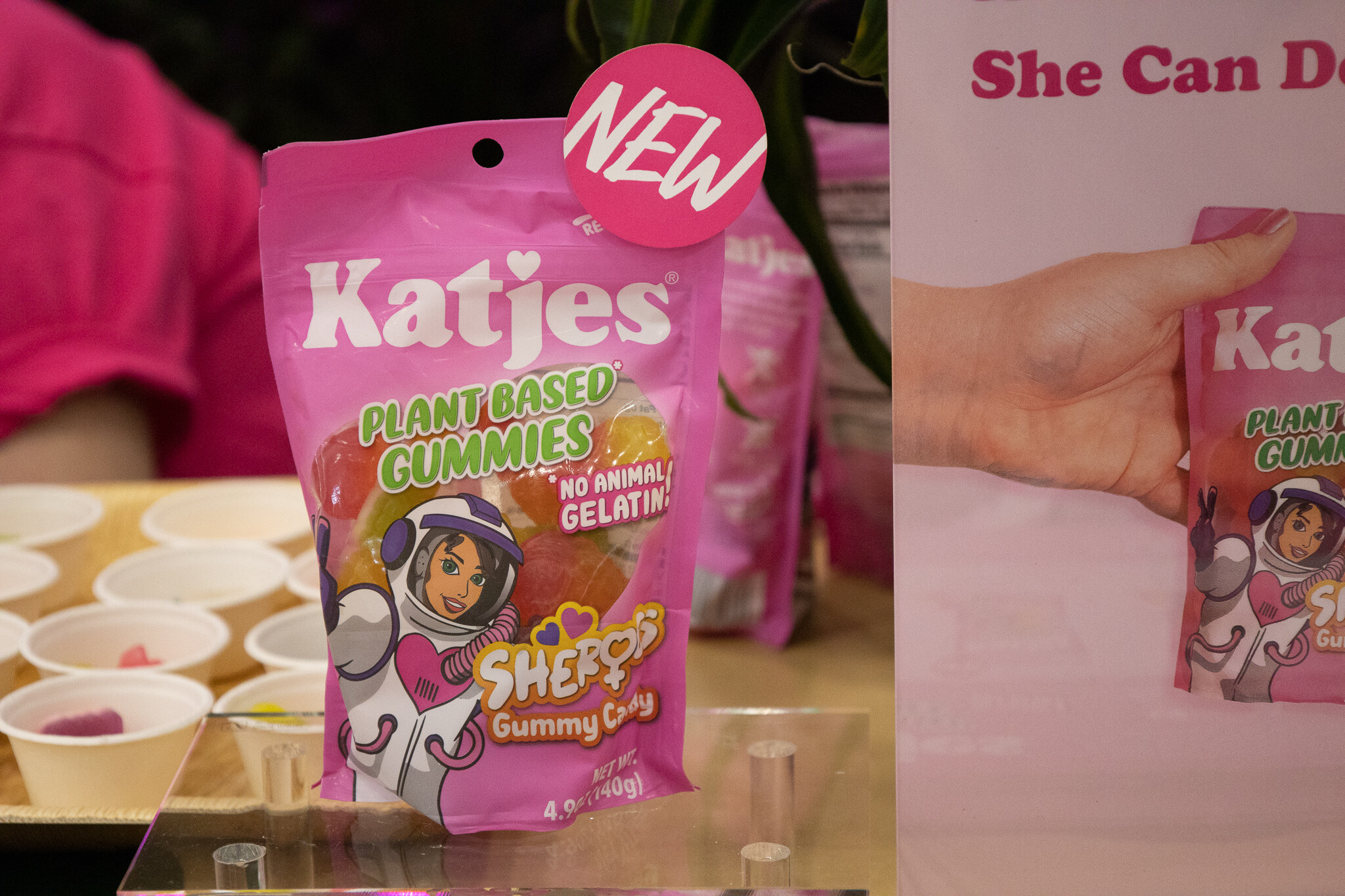 A bag of Katjes plant-based gummies held up near sample cups