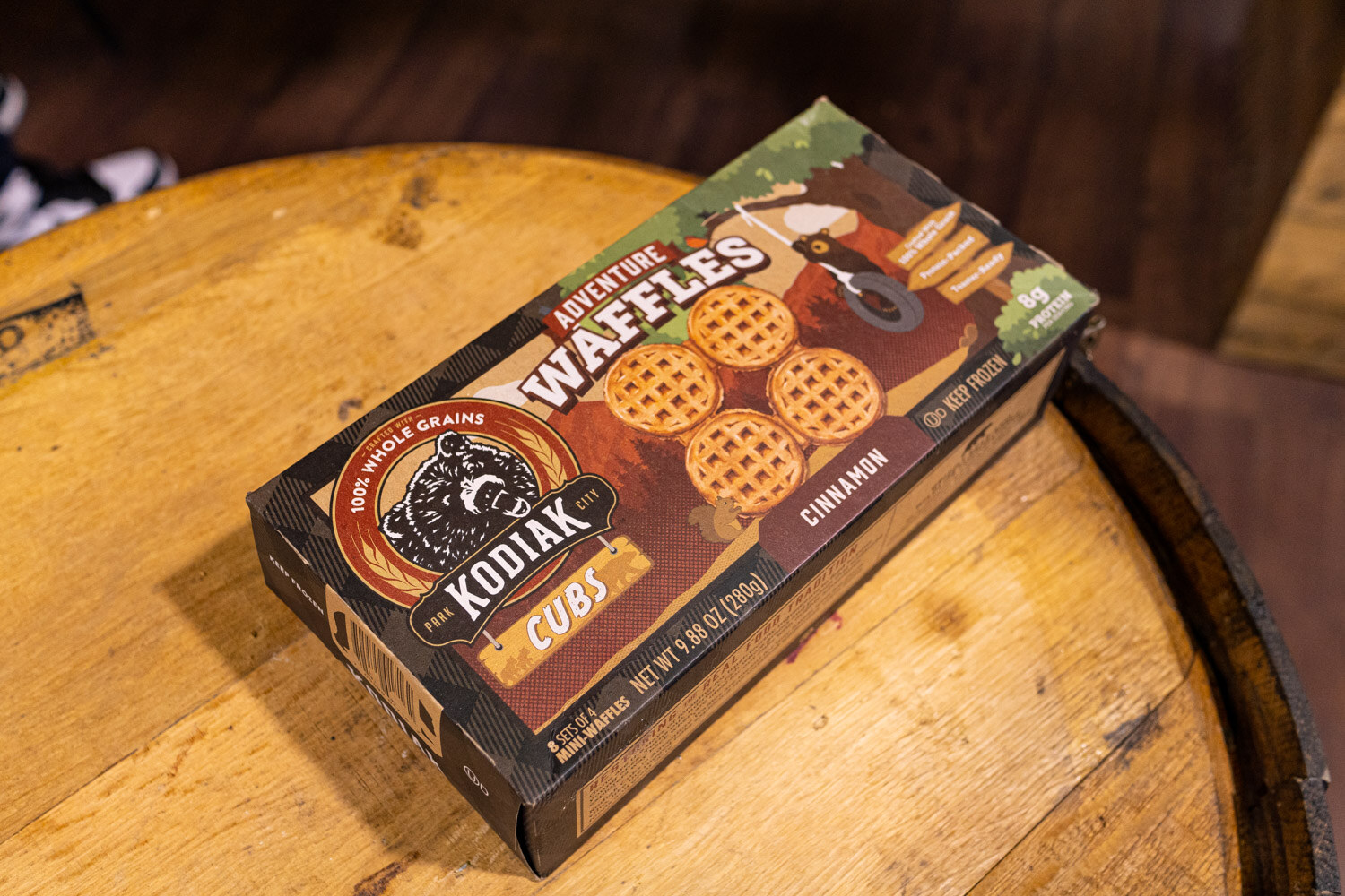 A box of Kodiak adventure waffles on a barrel top