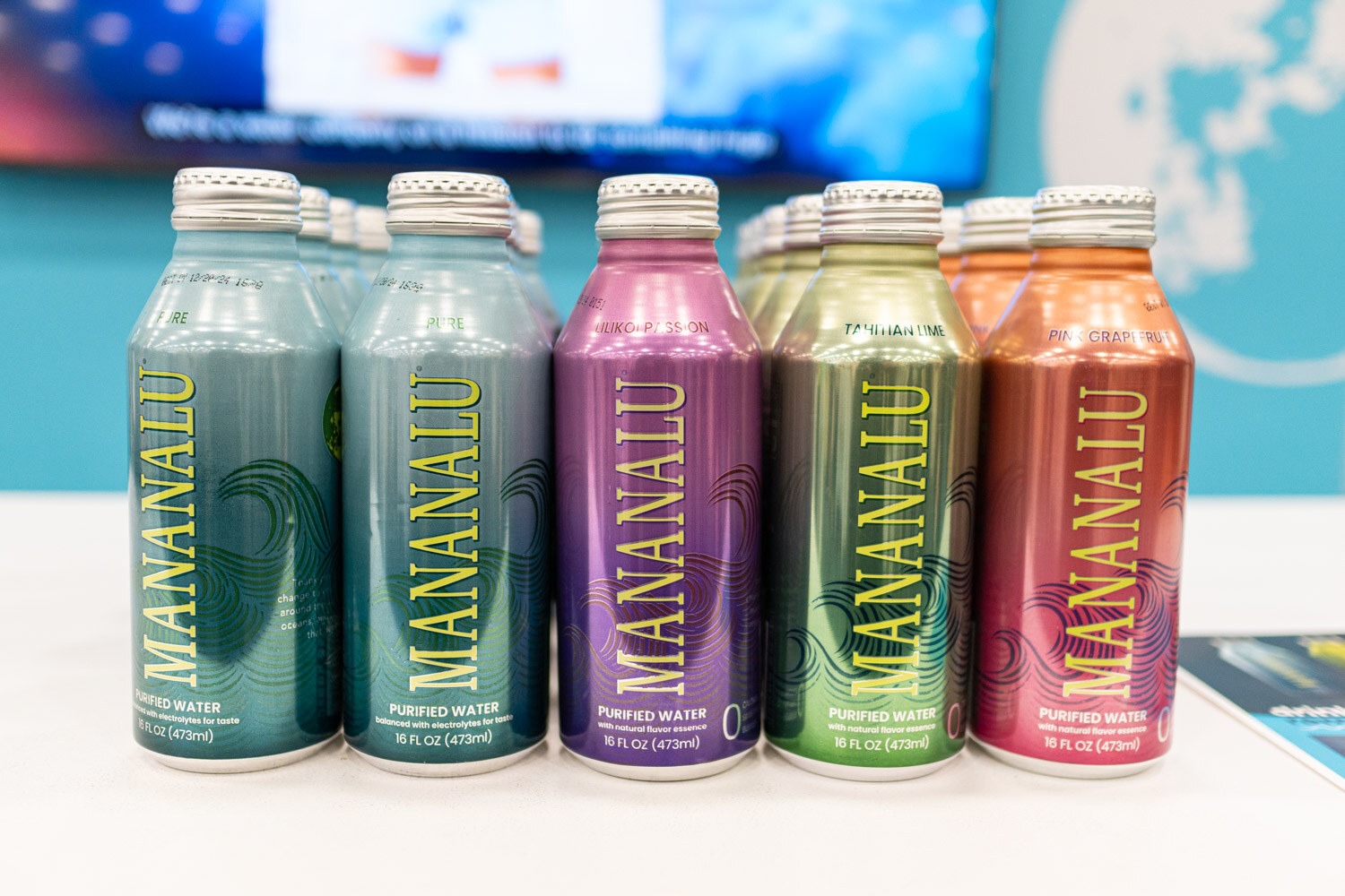 A group of colorful Mananalu aluminum bottles in teal, purple and orange