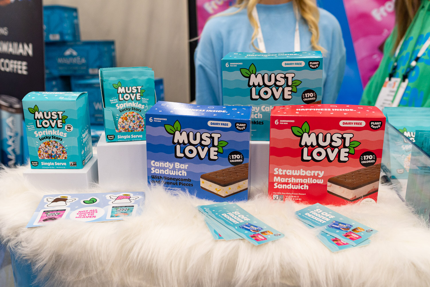 Must Love packaged ice cream sandwiches on a fluffy white display