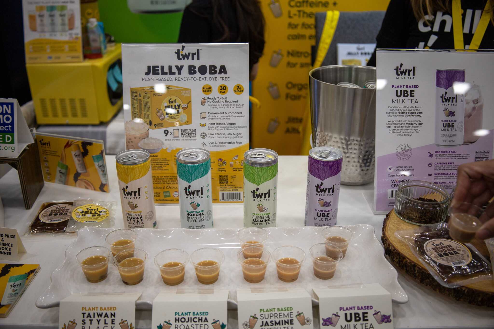 A table of Twrl plant-based milk tea cans and jelly boba samples
