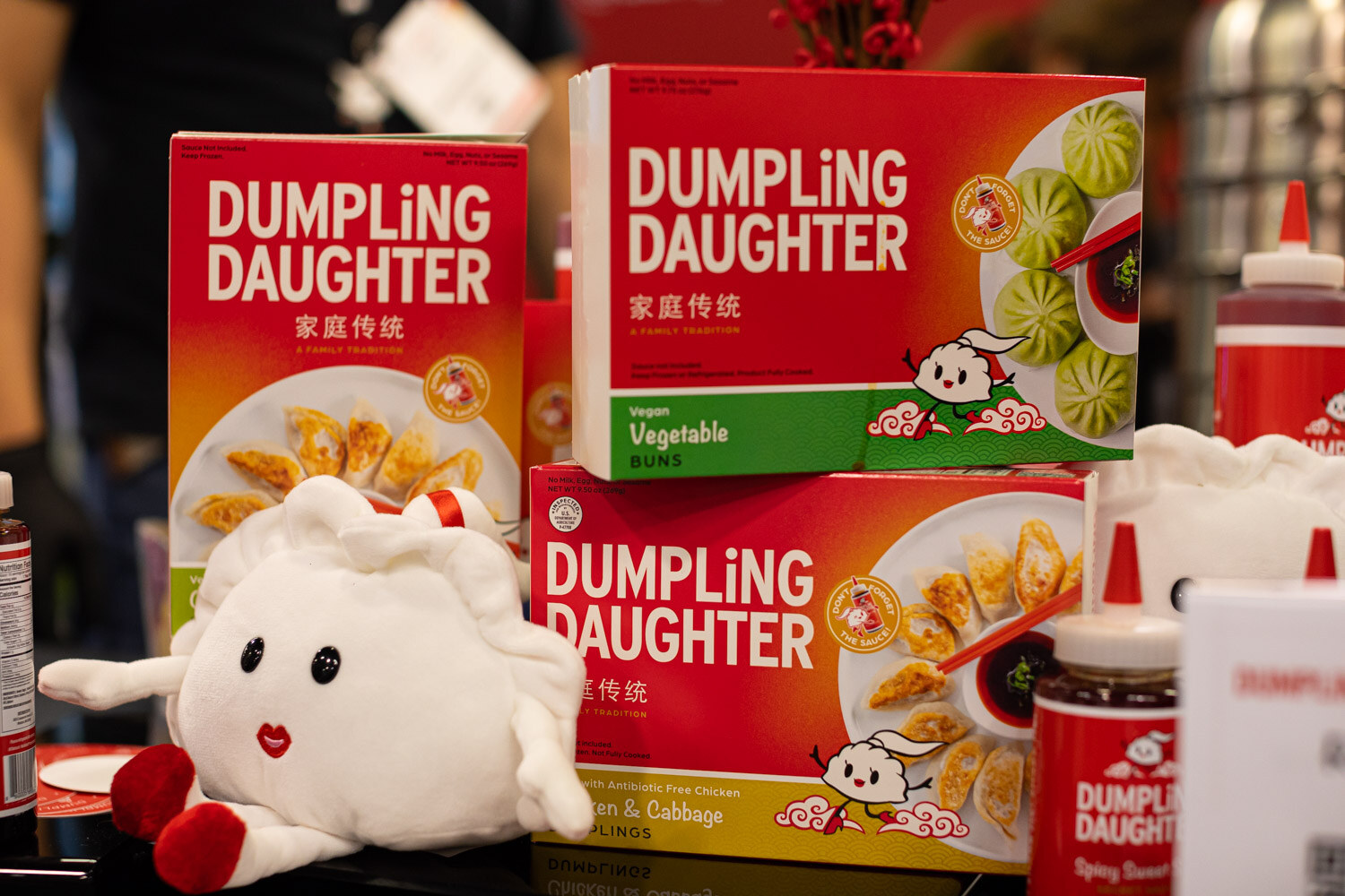 Boxes of Dumpling Daughter dumplings with a small plush dumpling character in front
