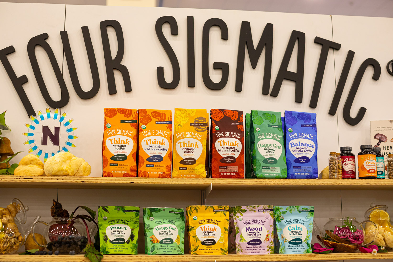 Shelves of Four Sigmatic bags and boxes under a Four Sigmatic sign