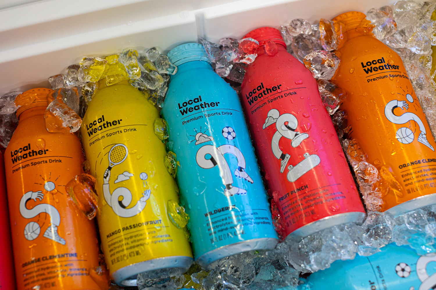 Orange, yellow, blue and red Local Weather sports drink bottles lying in ice