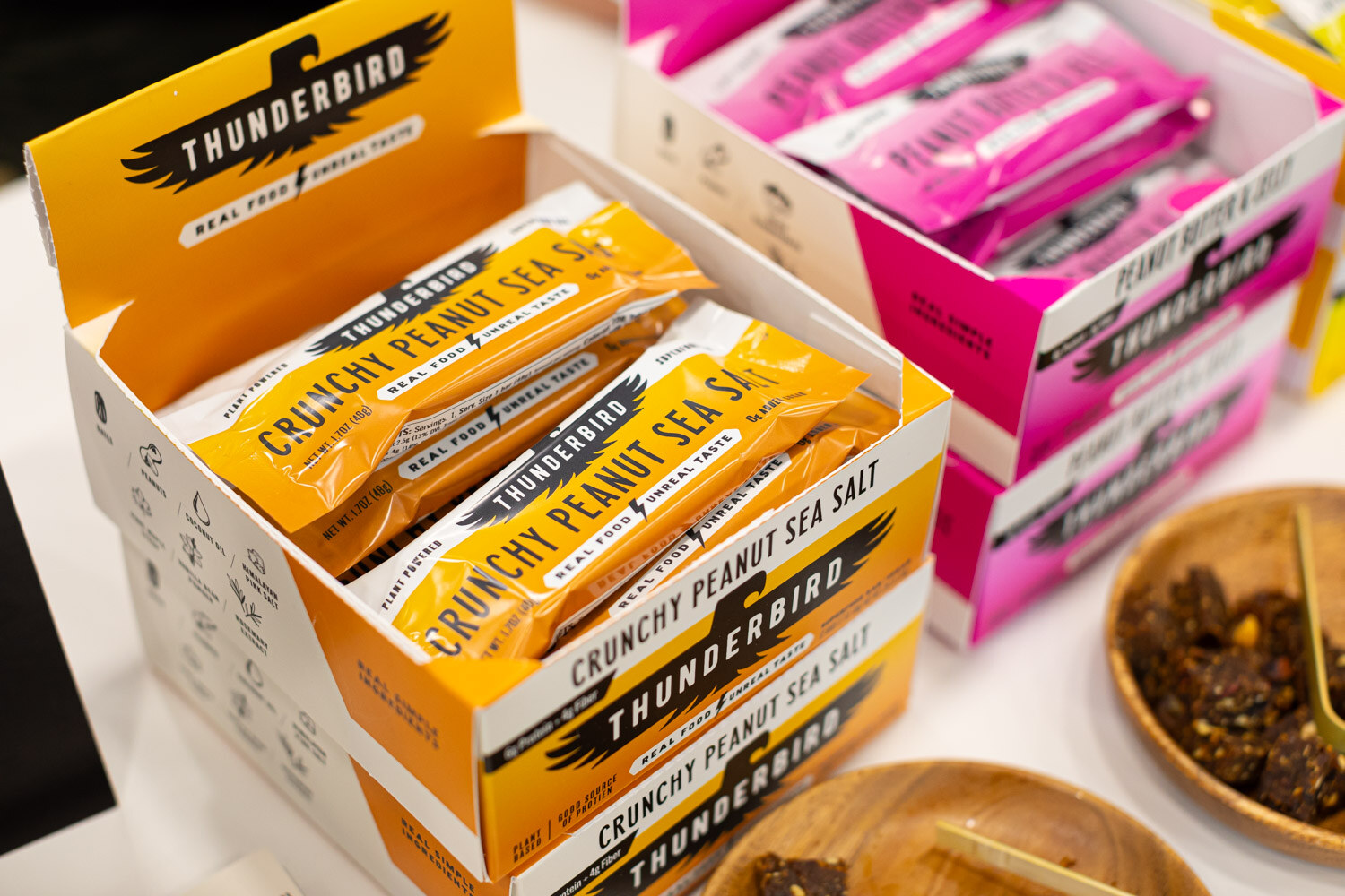 An open box of Thunderbird crunchy peanut sea salt bars on a table