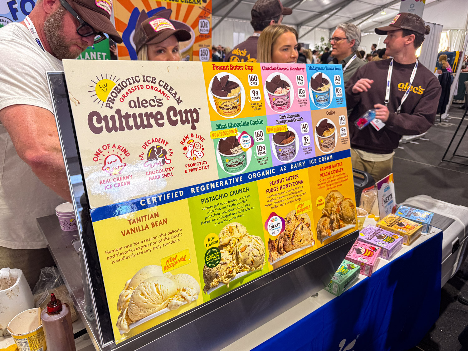 An Alec's Culture Cup probiotic ice cream flavor display with attendees behind it