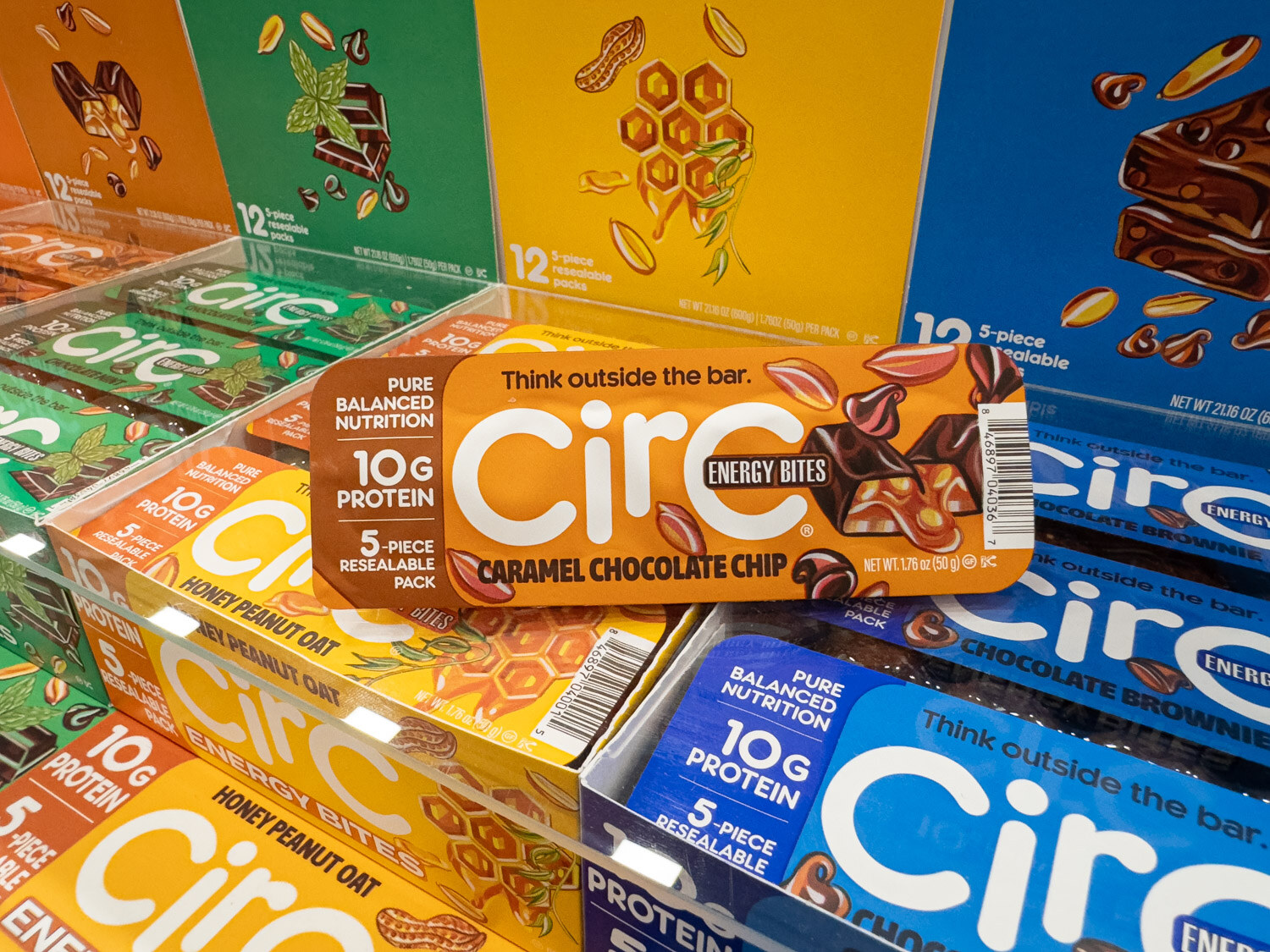 Boxes of Circ energy bars and protein bars stacked in a colorful display