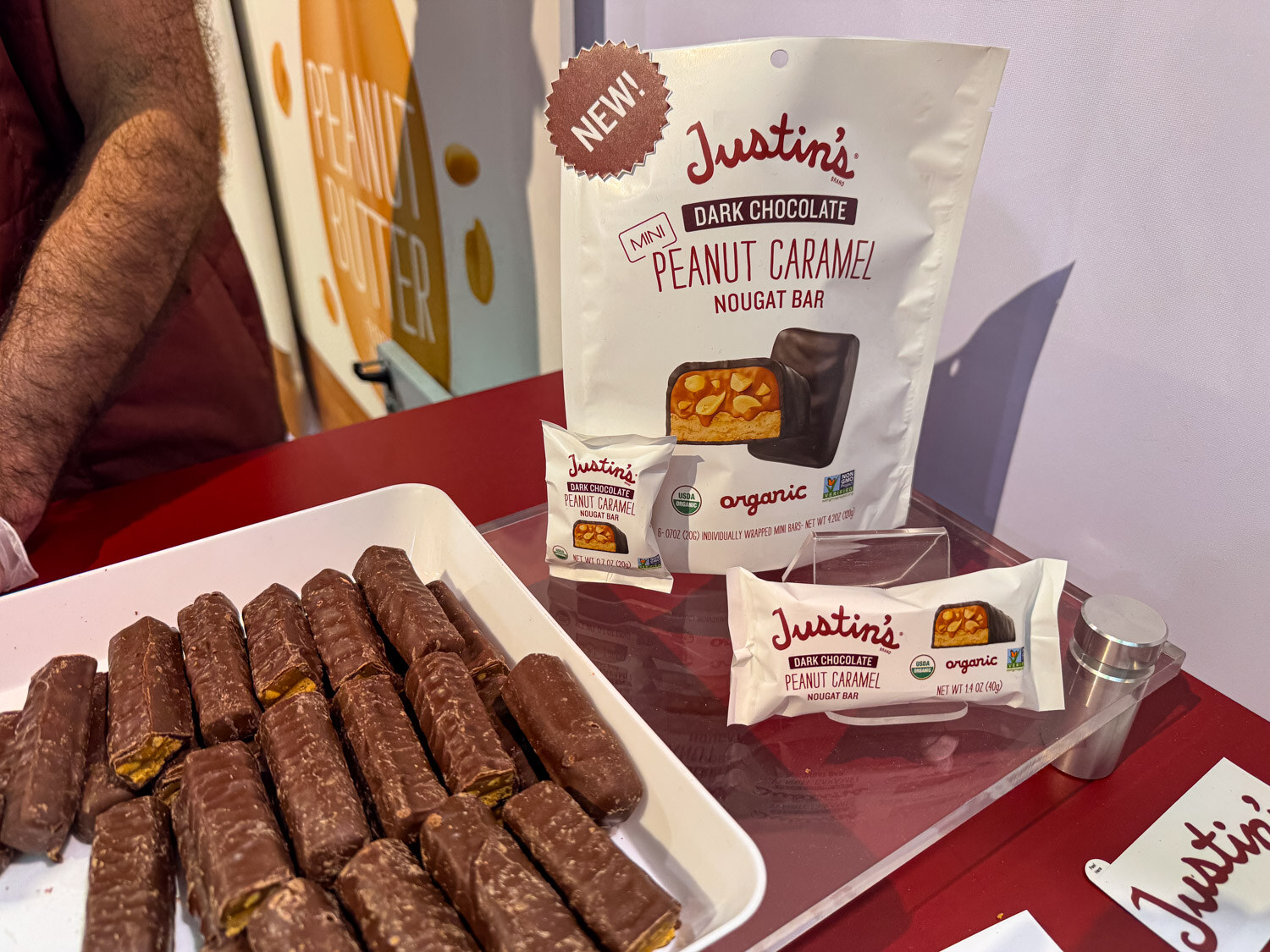 Justin's peanut caramel nougat bars in a tray with a Justin's bag behind them