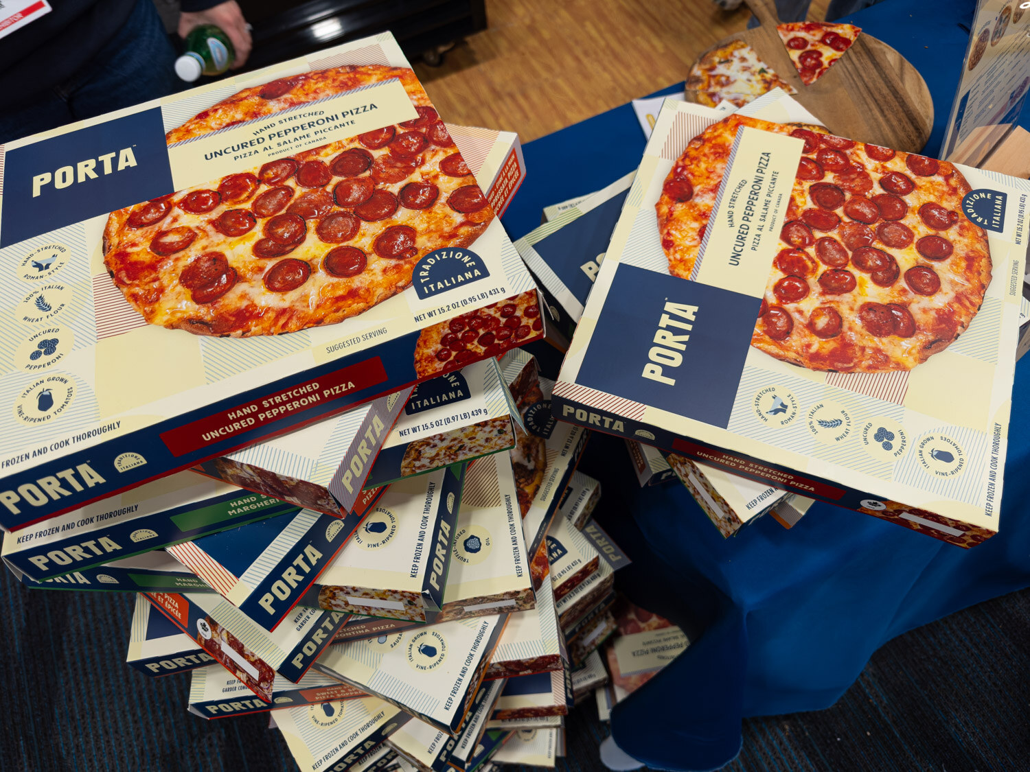 A pile of Porta pizza boxes showing pepperoni pizza