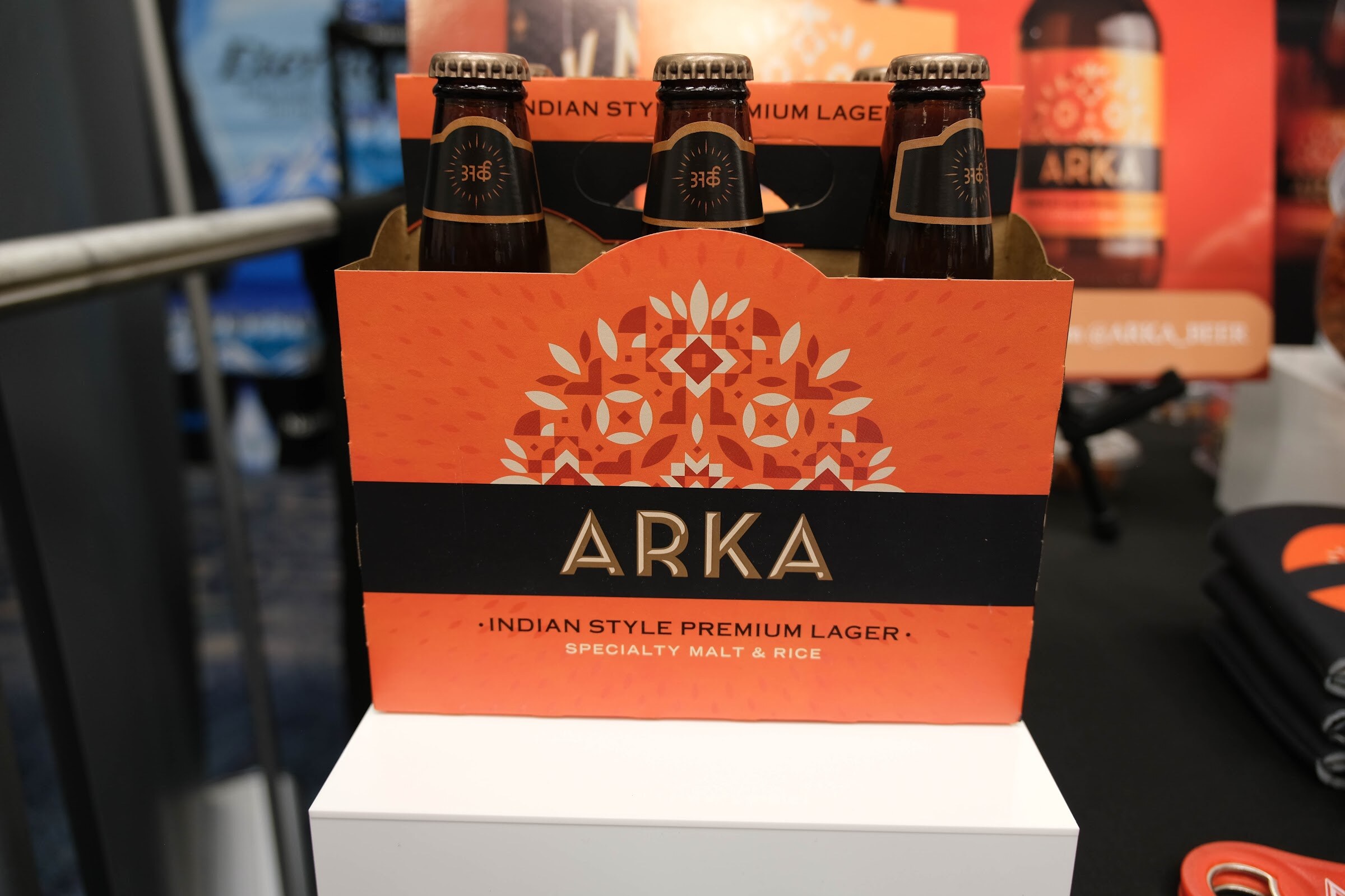 Orange Arka Indian Style Premium Lager six-pack carrier with bottles on a white display.
