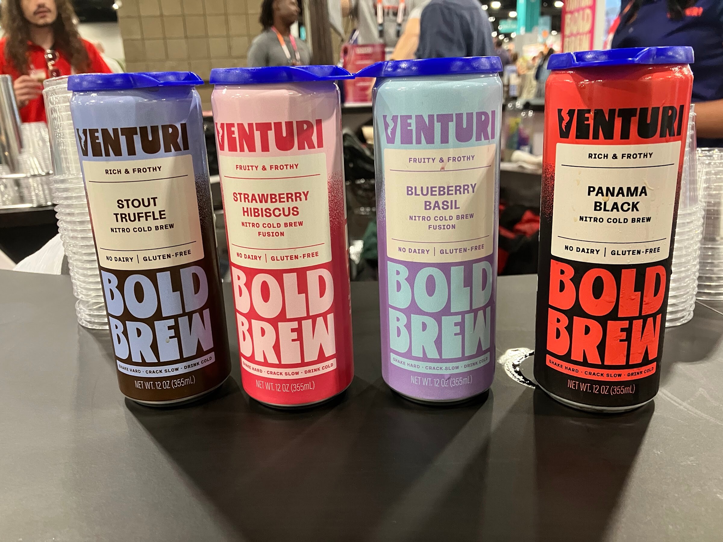 Four cans of Venturi Bold Brew nitro cold brew in Stout Truffle, Strawberry Hibiscus, Blueberry Basil and Panama Black.