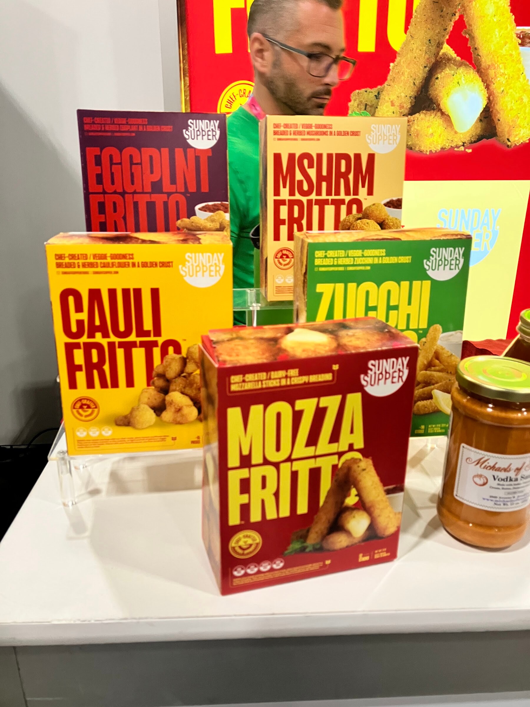 Colorful boxes of Sunday Supper Mozza Fritto, Cauli Fritto, Zucchi and Eggplnt Fritto on a display.