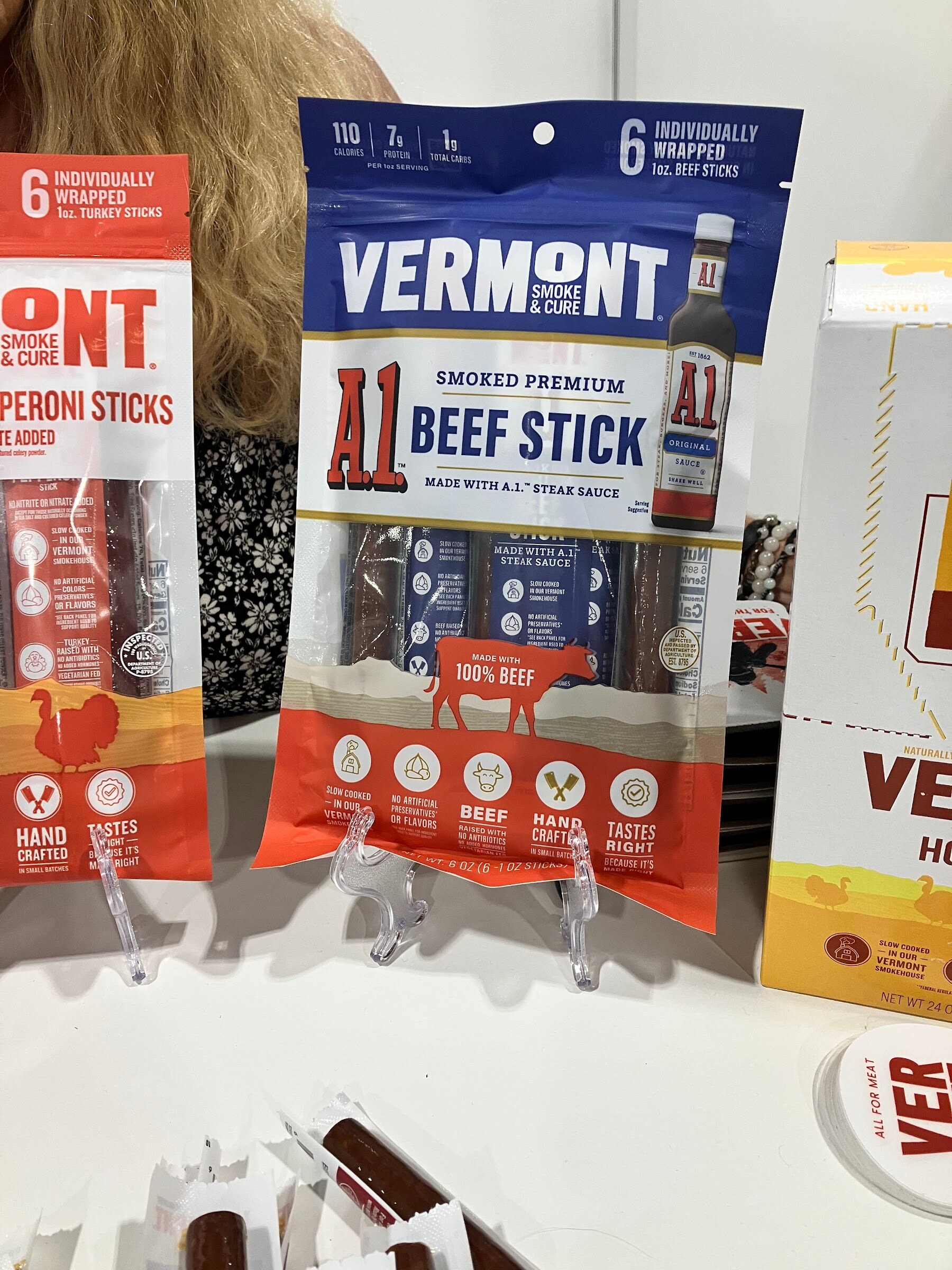 Packages of Vermont Smoke & Cure A.1. smoked premium beef sticks on a display stand.