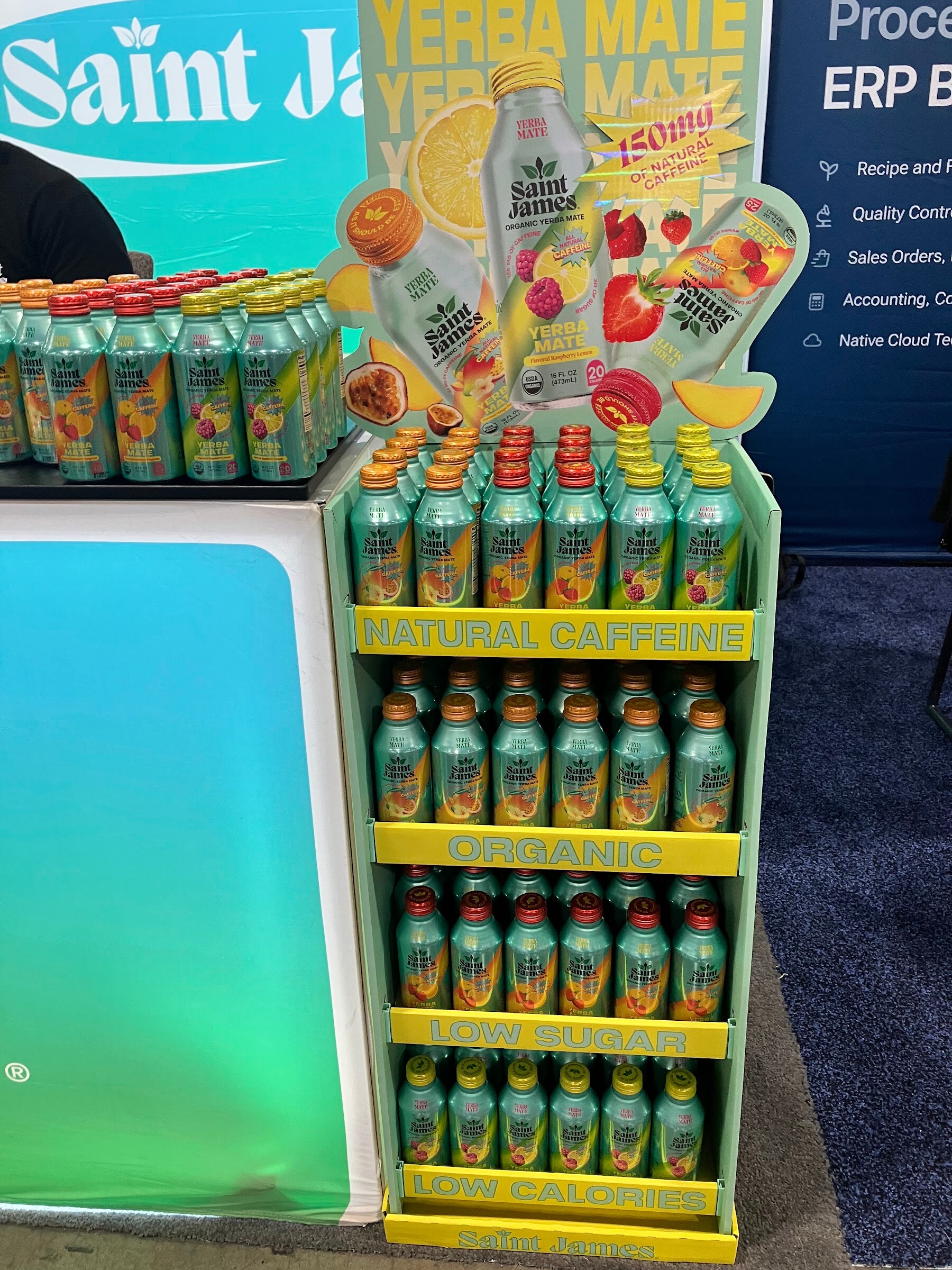 Tiered floor display of green Saint James yerba mate bottles with natural caffeine and organic signage.