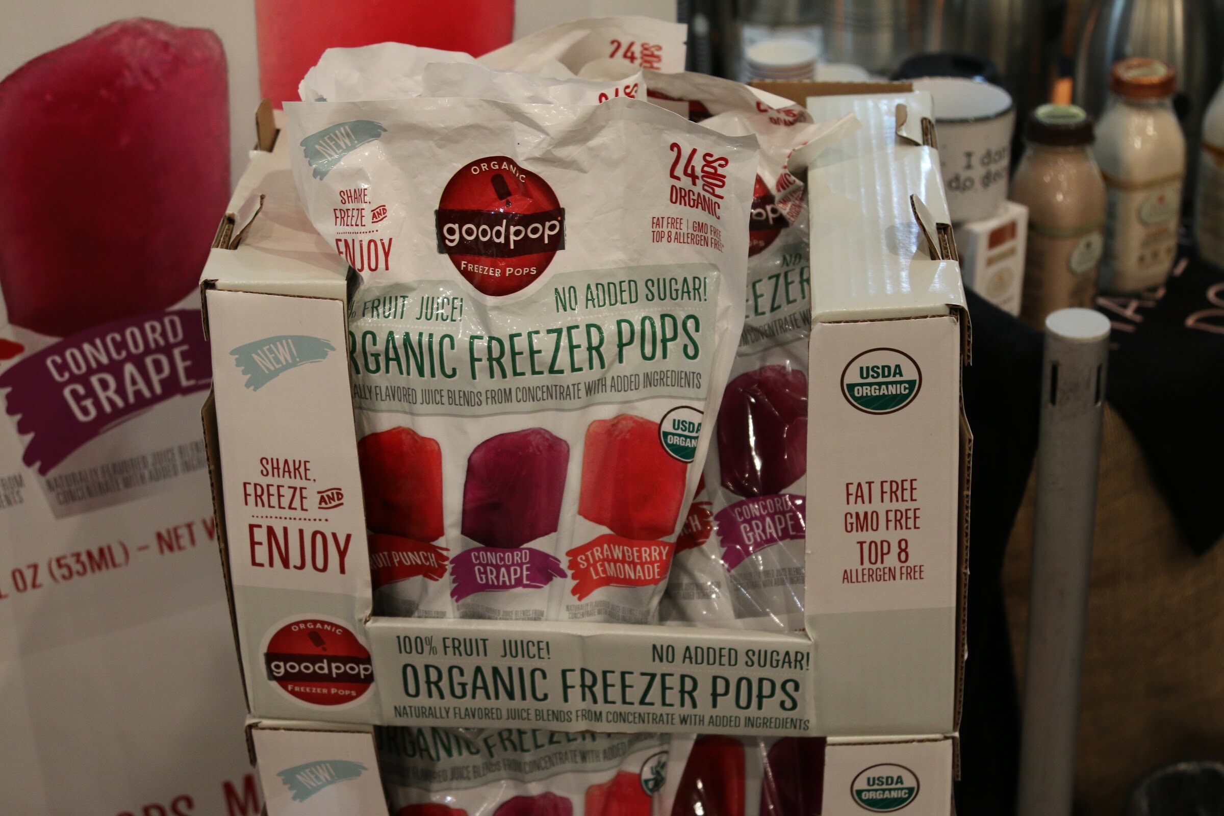 A white display carton of GoodPop organic freezer pops with a bag open at the top.