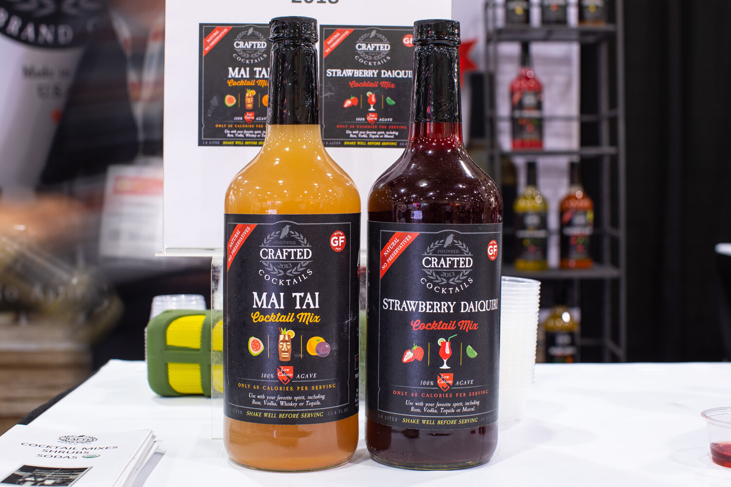 Two bottles labeled Crafted Cocktails Mai Tai and Strawberry Daiquiri mix.