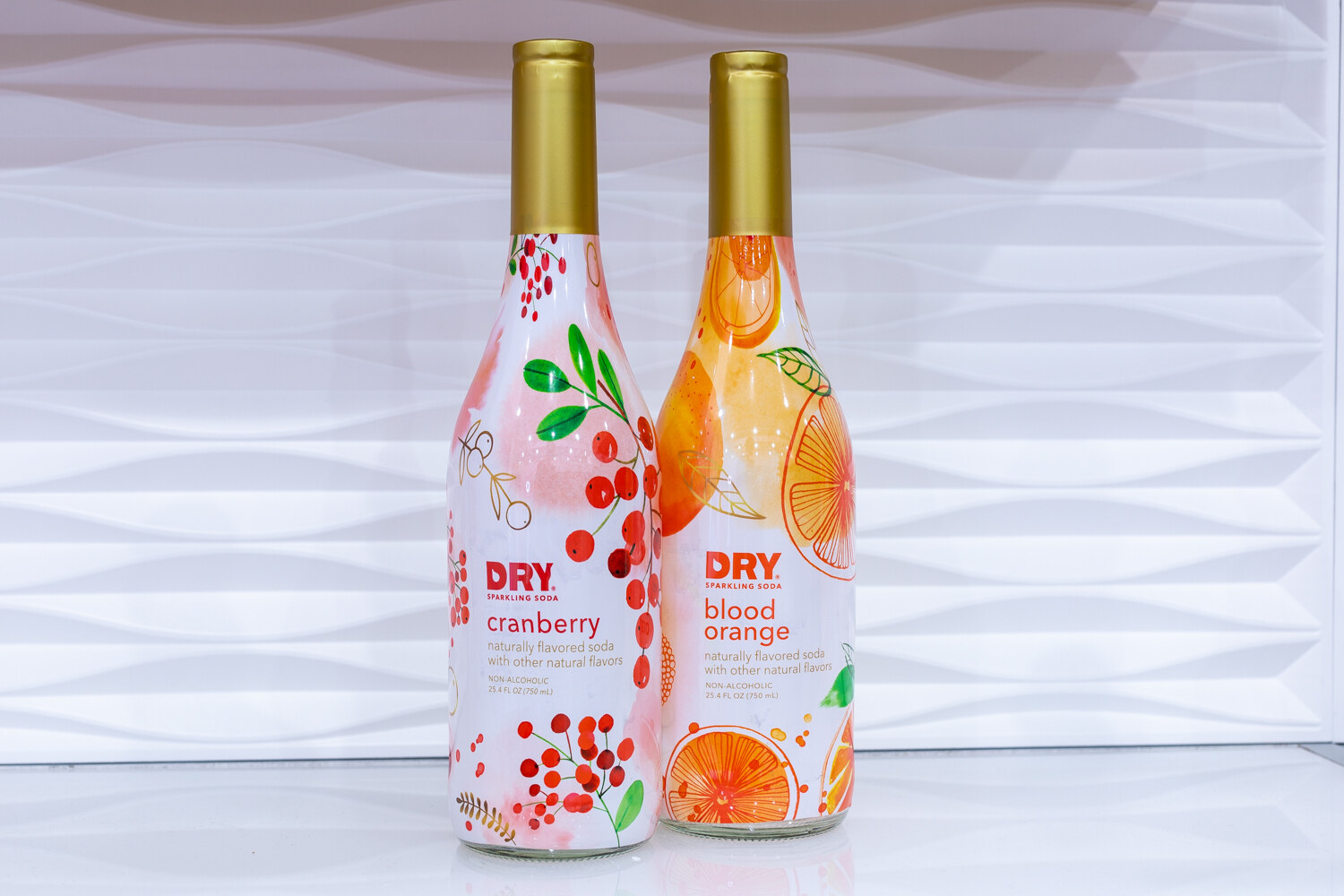 Two bottles labeled Dry in cranberry and blood orange.