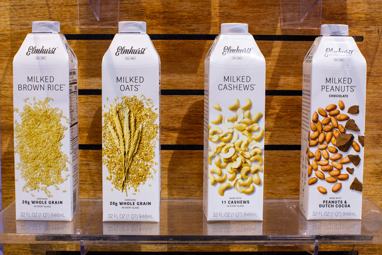 Four cartons of Elmhurst milked brown rice, oats, cashews and peanuts.