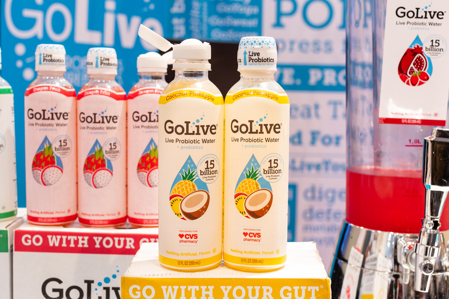 Bottles of GoLive probiotic water in front of a GoLive banner.