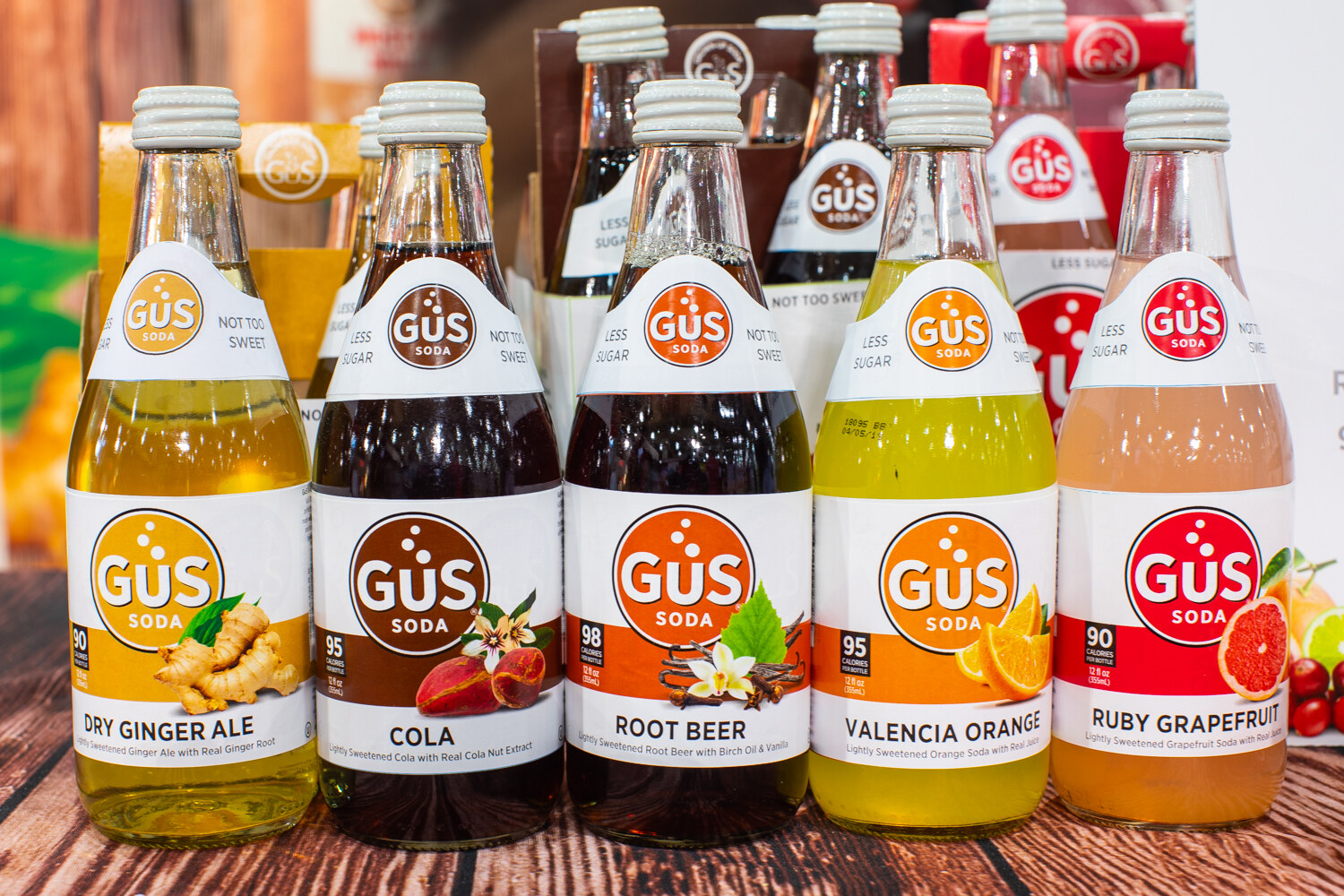Glass bottles of Gus soda in ginger ale, cola, root beer, Valencia orange and ruby grapefruit.