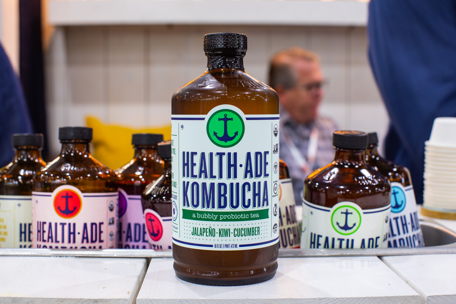 A Jalapeno-Kiwi-Cucumber Health-Ade bottle in front of other kombucha flavors.
