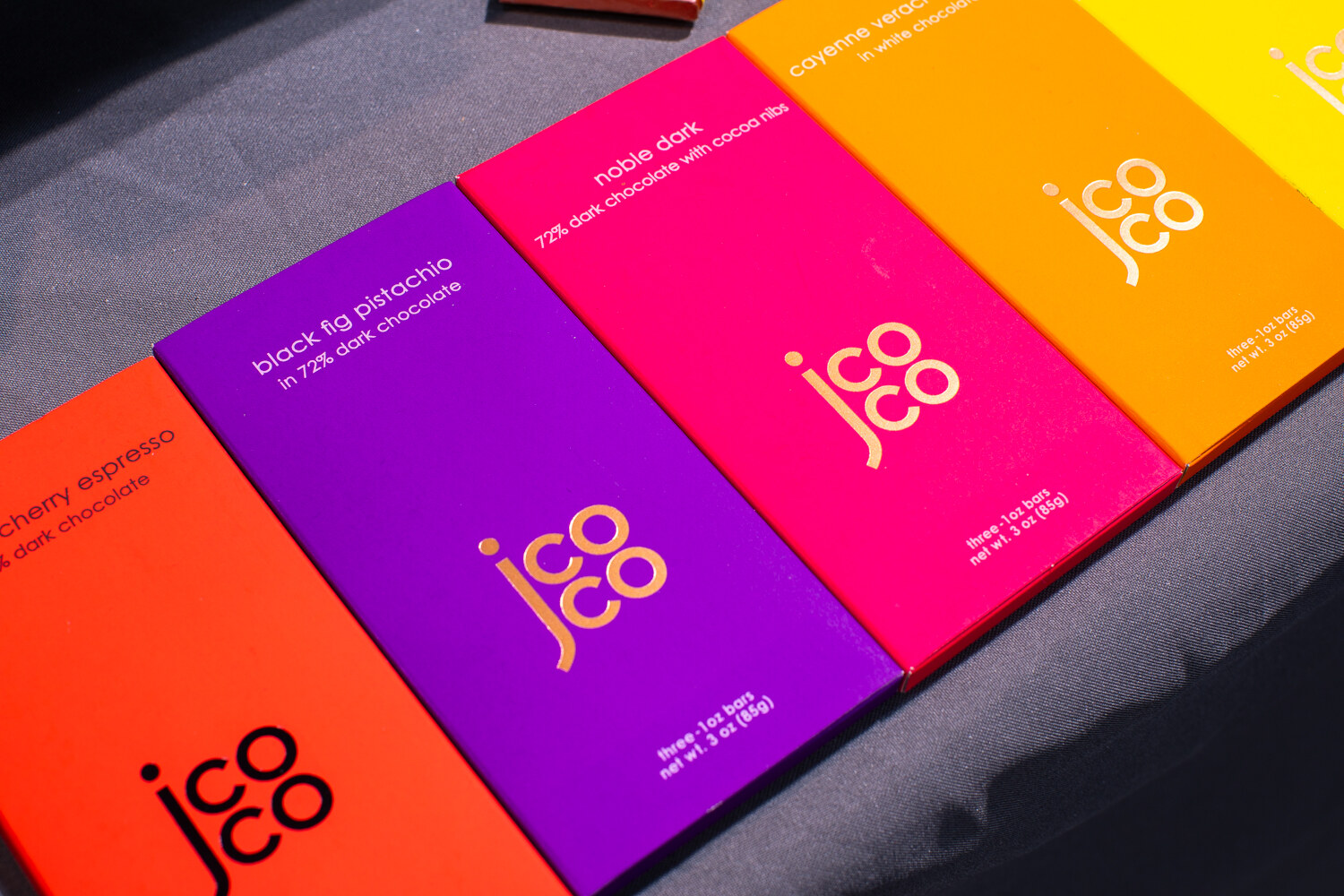 Bars in orange, purple, magenta and yellow wrappers.
