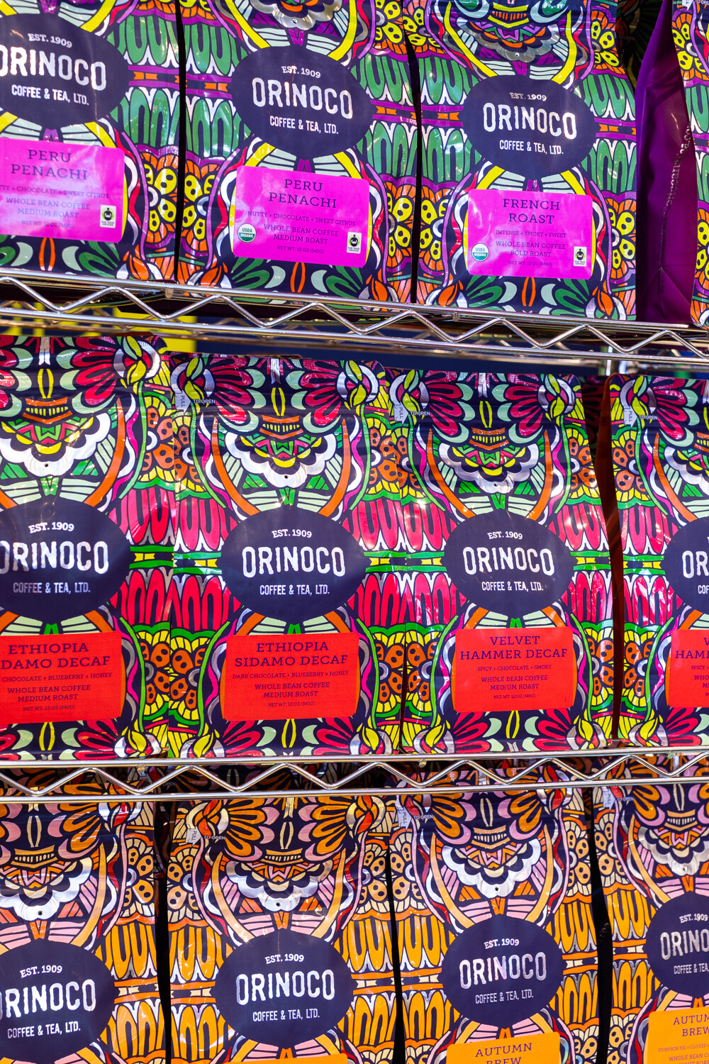 Shelves of colorful Orinoco Coffee & Tea packages.