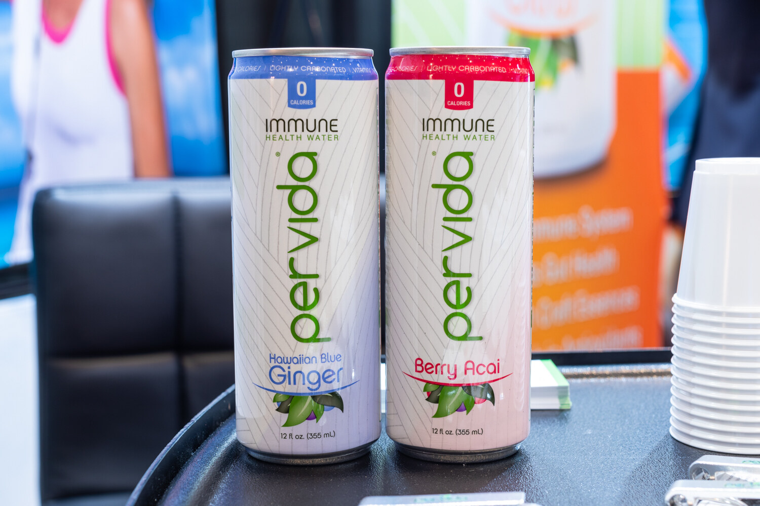 Two Pervida cans in Hawaiian blue ginger and berry acai.