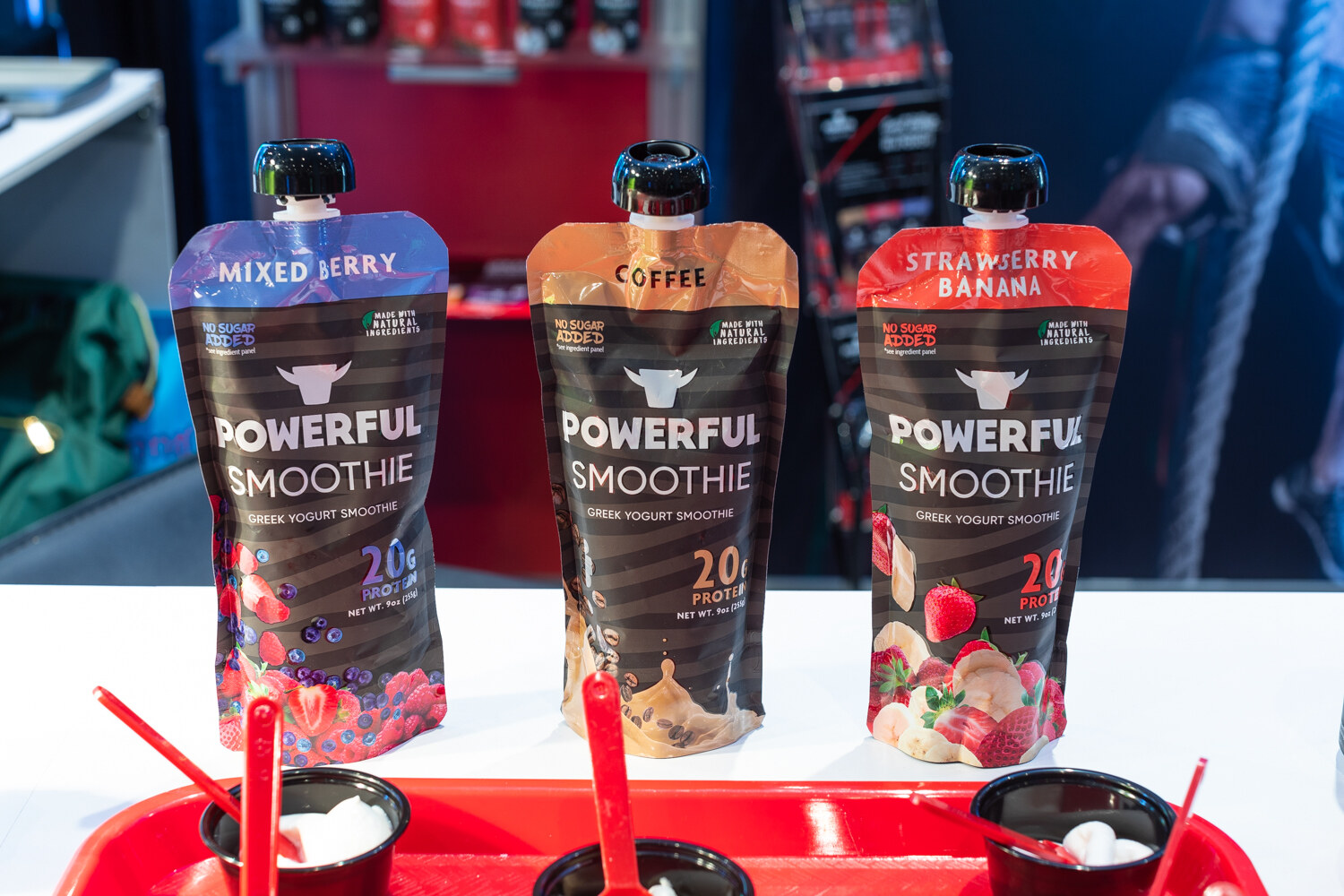 Three Powerful Smoothie pouches in mixed berry, coffee and strawberry banana.