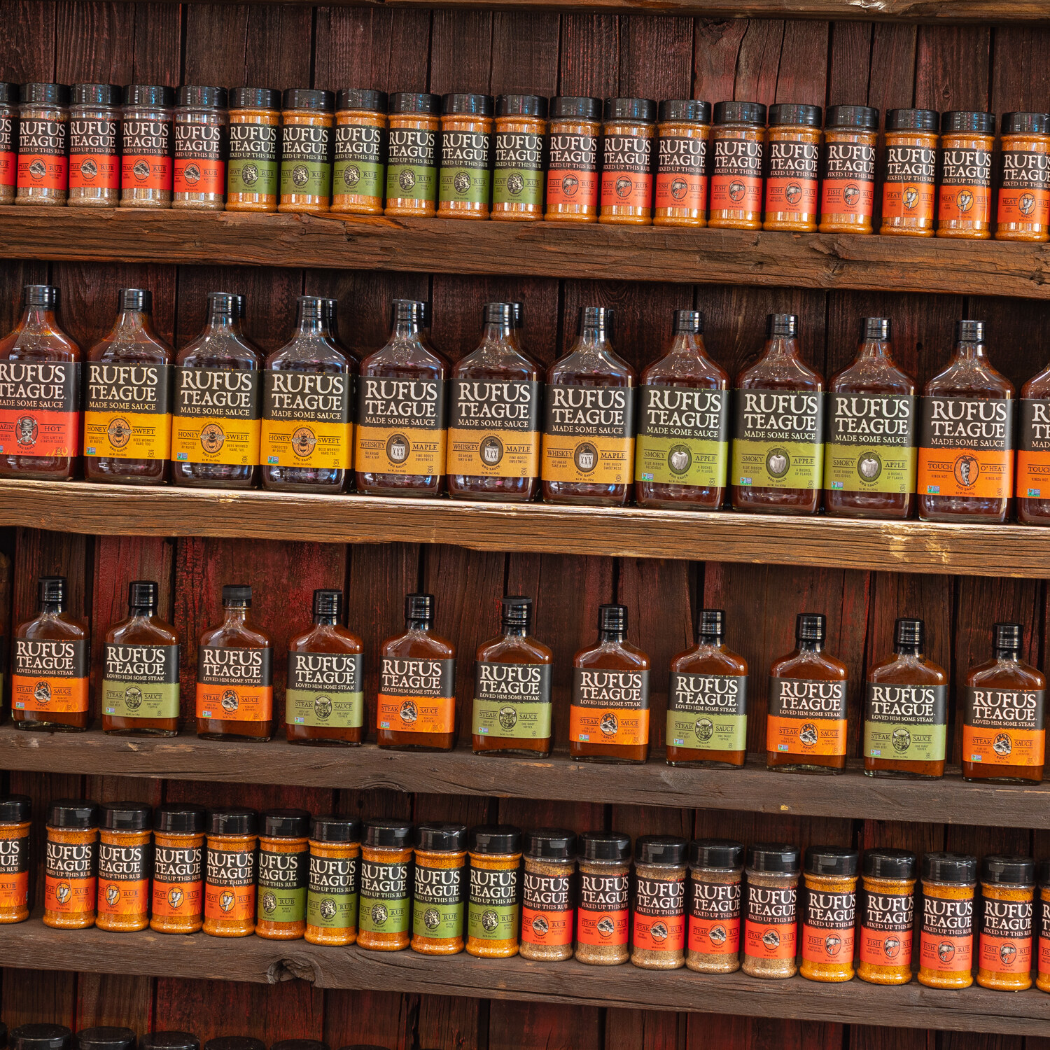 Shelves of Rufus Teague sauce and rub bottles.