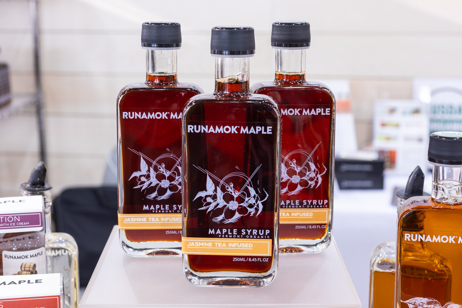 Three bottles of Runamok Maple on a white display.