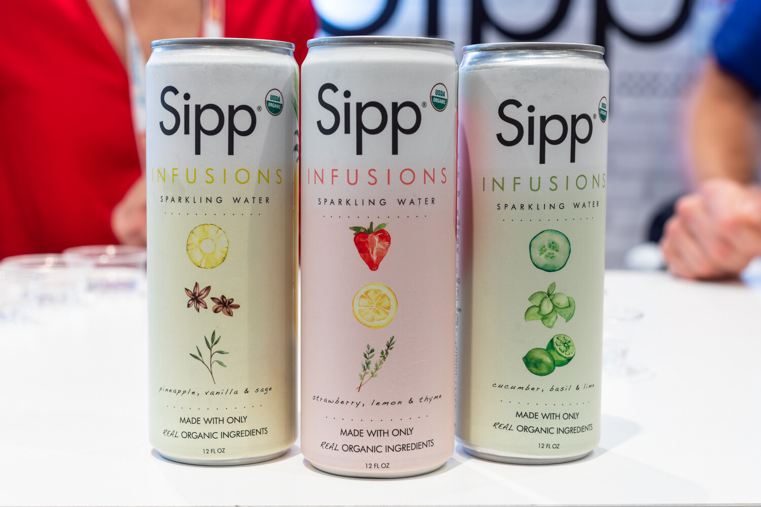 Three white Sipp cans against a plain background.