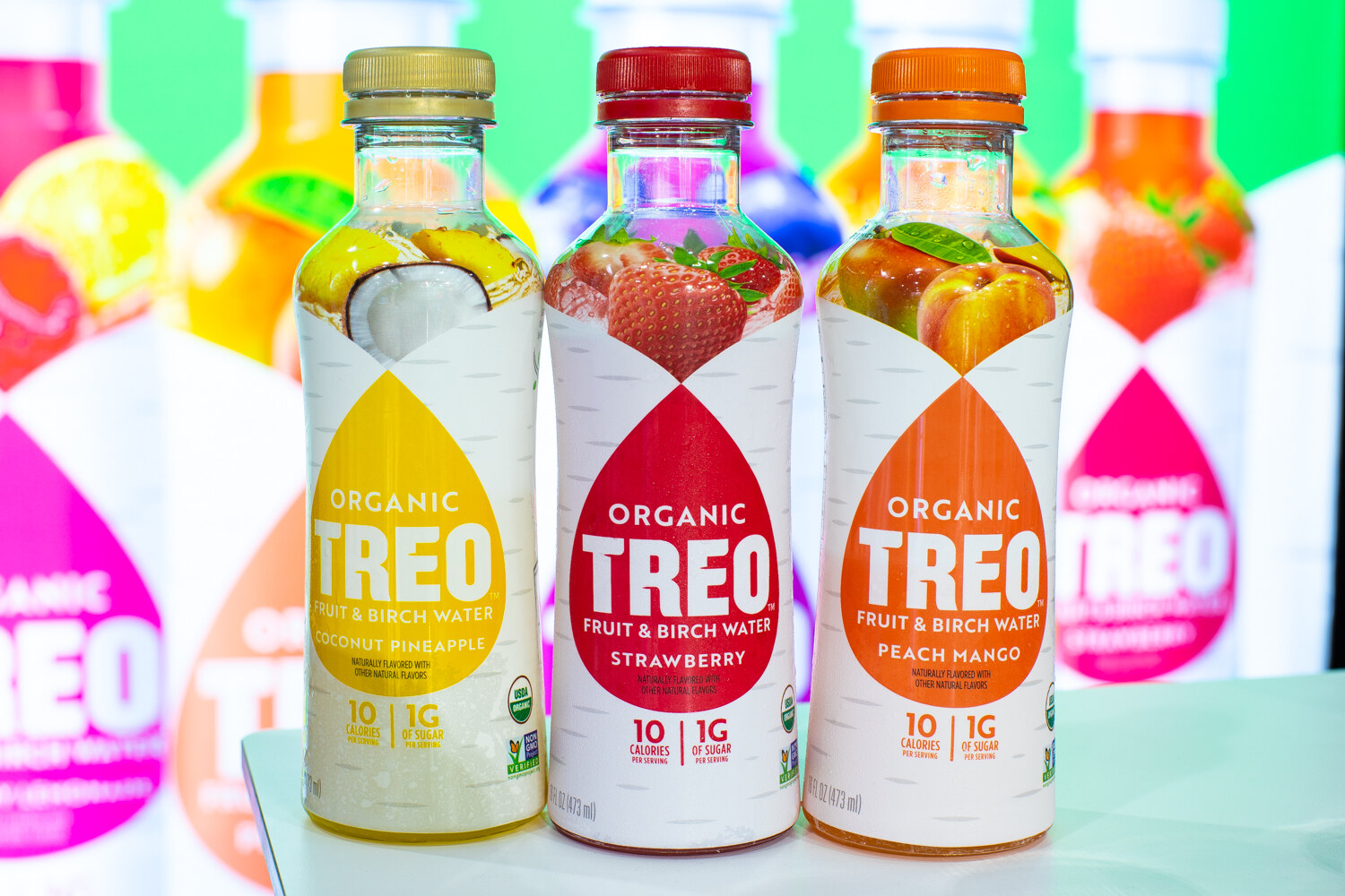 Three Treo bottles in coconut pineapple, strawberry and peach mango.