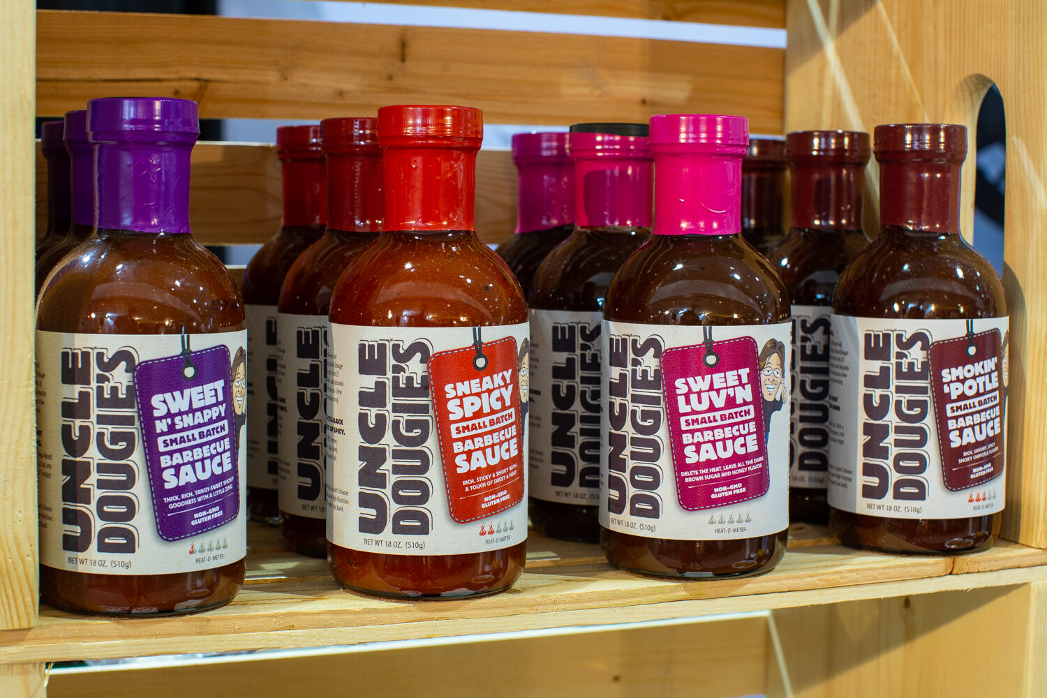 Bottles labeled Uncle Dougie's in Sweet N' Snappy and Sneaky Spicy.