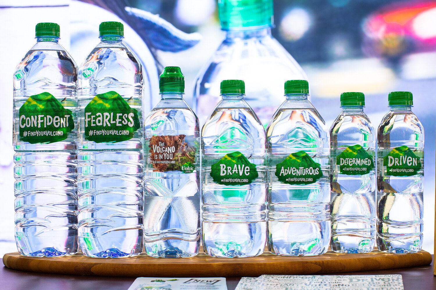 Water bottles with green caps and labels such as Confident, Fearless, Brave and Driven.