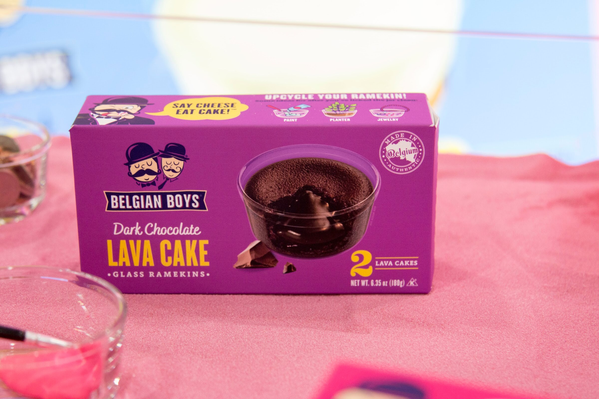 Photo of a Belgian Boys dark chocolate lava cake box on a pink tablecloth.