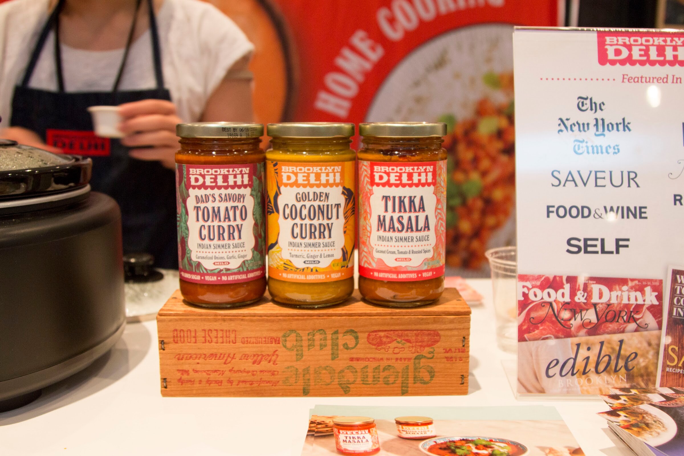 Photo of three jars of Brooklyn Delhi simmer sauces on a wooden crate.