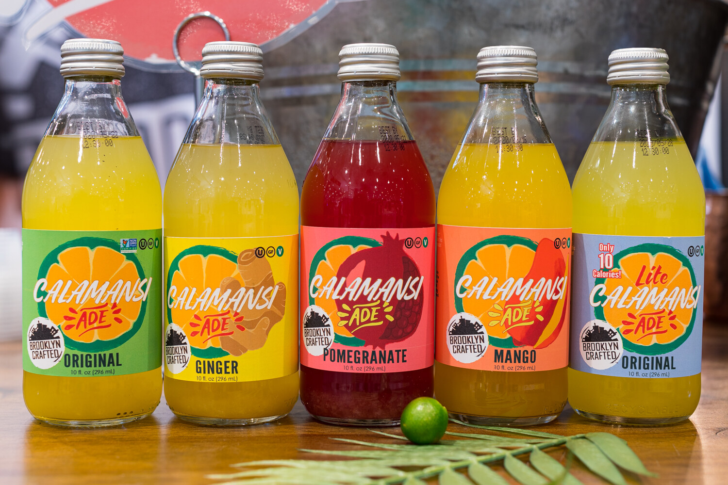 Photo of bottles of Brooklyn Crafted Calamansi Ade with a lime.