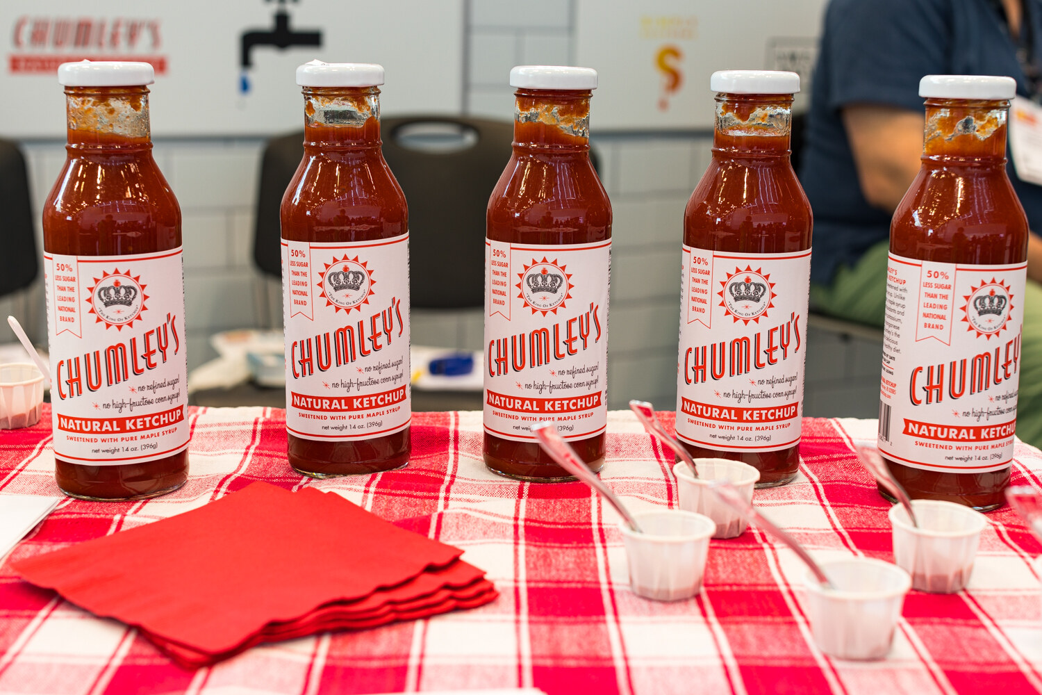 Photo of bottles of Chumley's natural ketchup on a red gingham cloth.