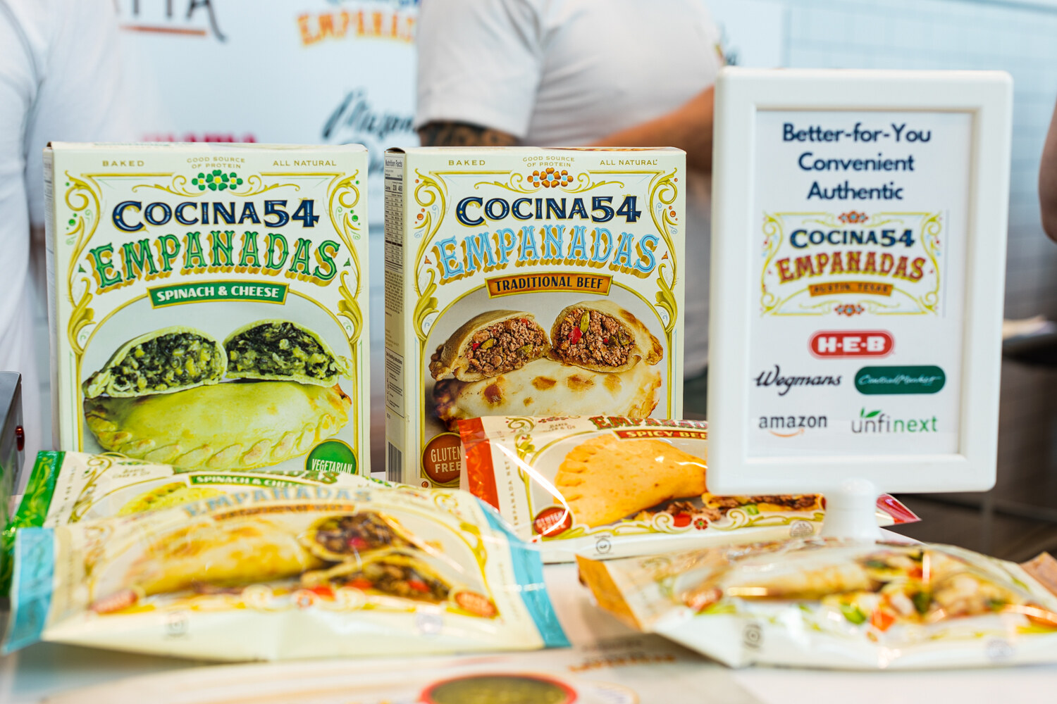 Photo of Cocina54 empanada boxes and samples.