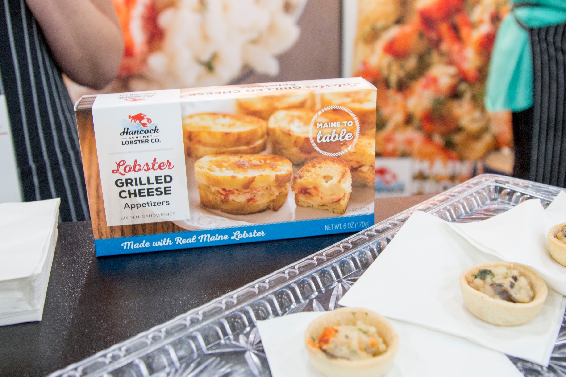 Photo of a Hancock Gourmet Lobster Co. grilled cheese appetizer box and samples.