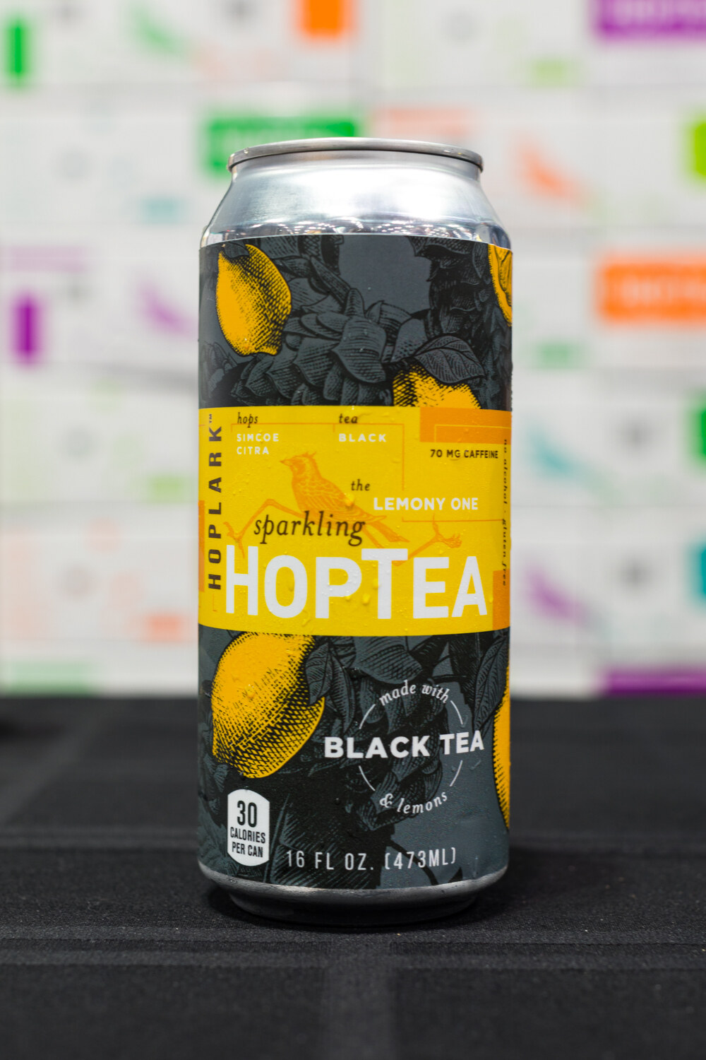Photo of a can of Hoplark HopTea black tea with lemon on a black table.
